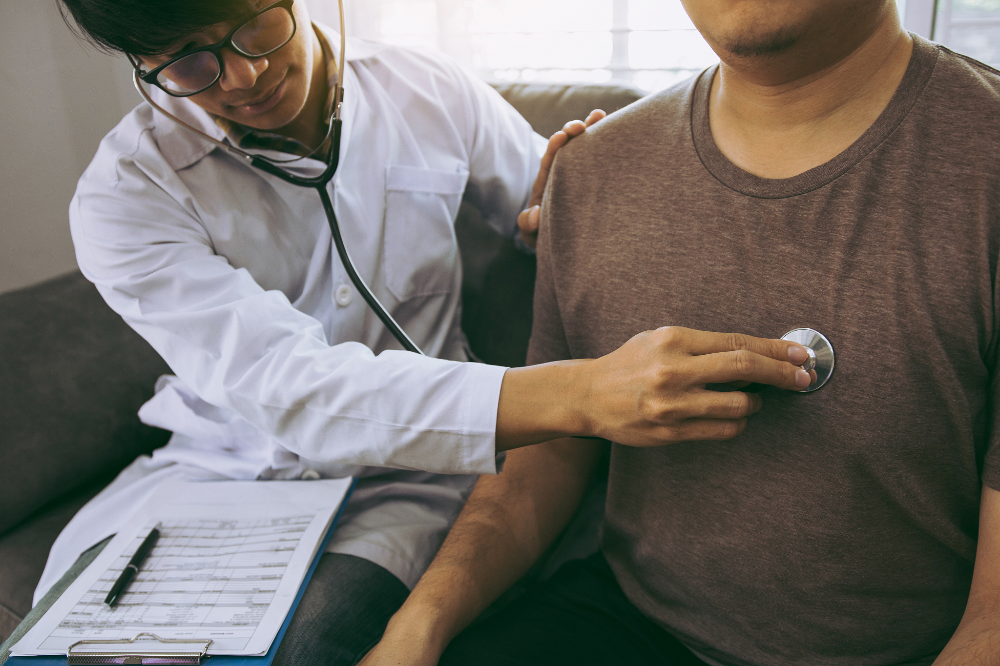 asian doctor is using a stethoscope listen to the heartbeat of t
