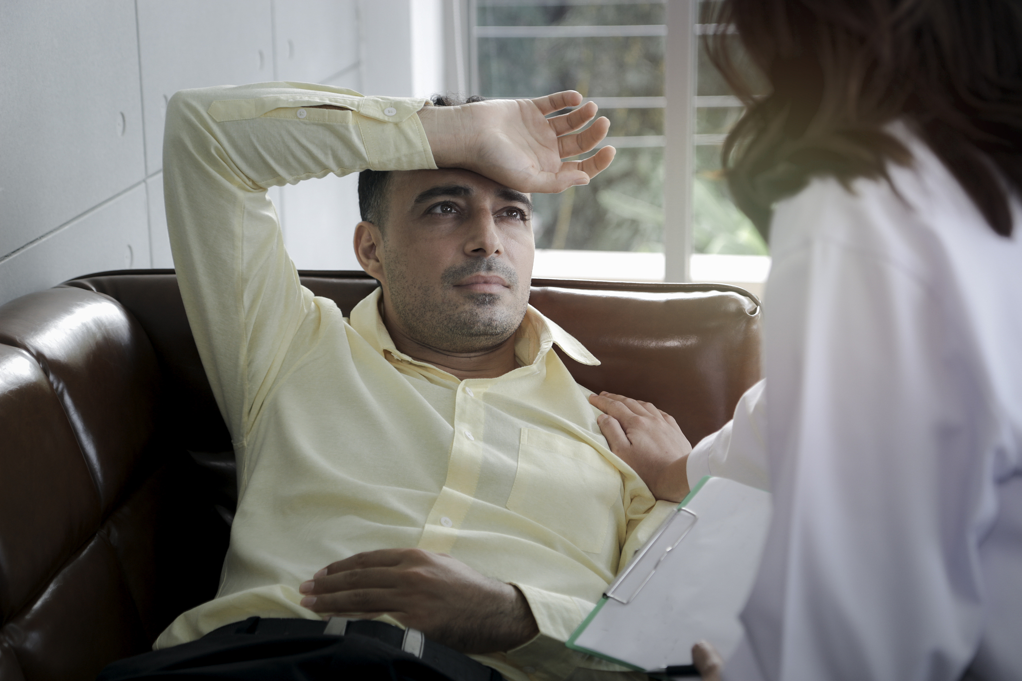 depressed patient having consultation with doctor, man getting u