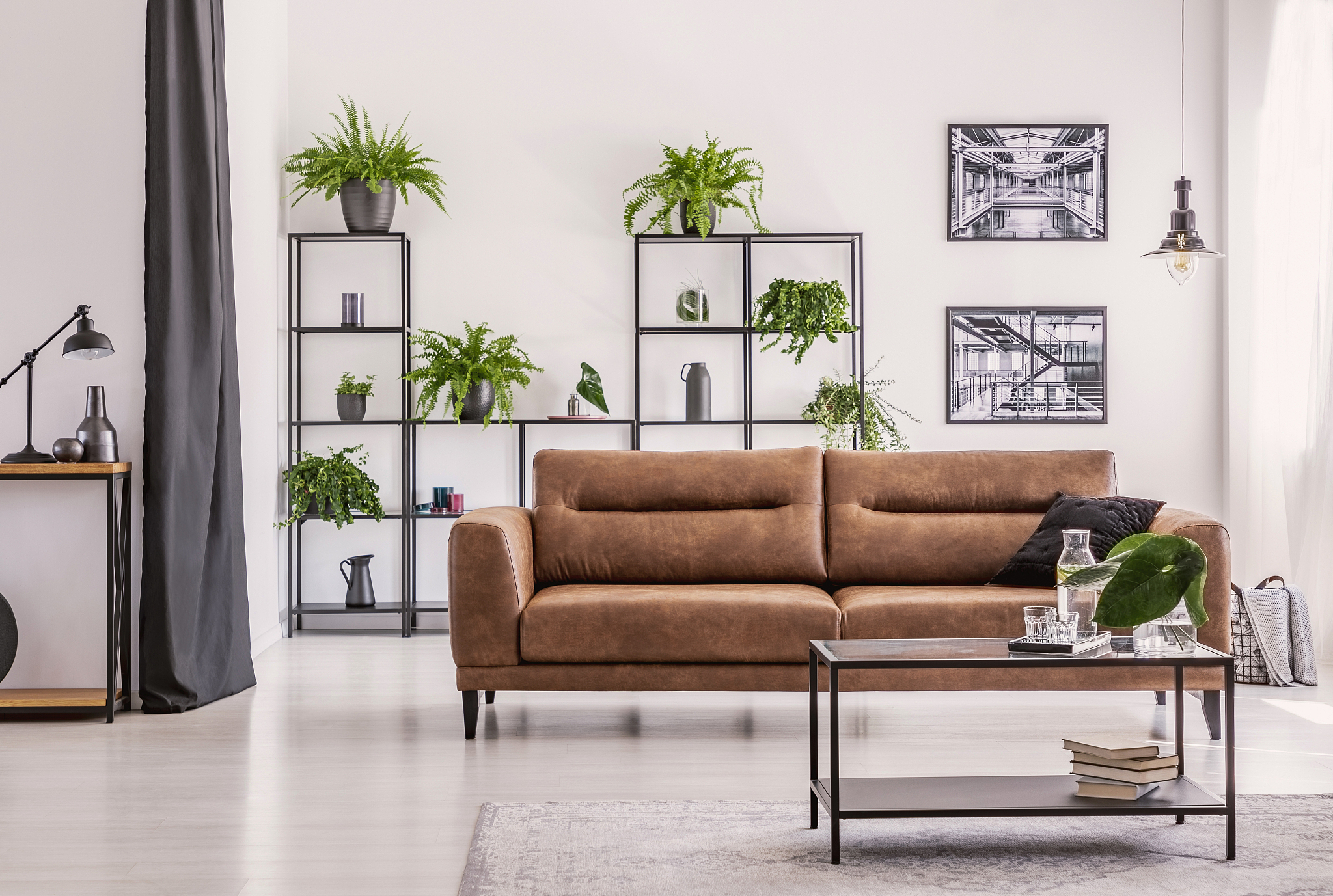 table in front of brown sofa in white living room interior with 