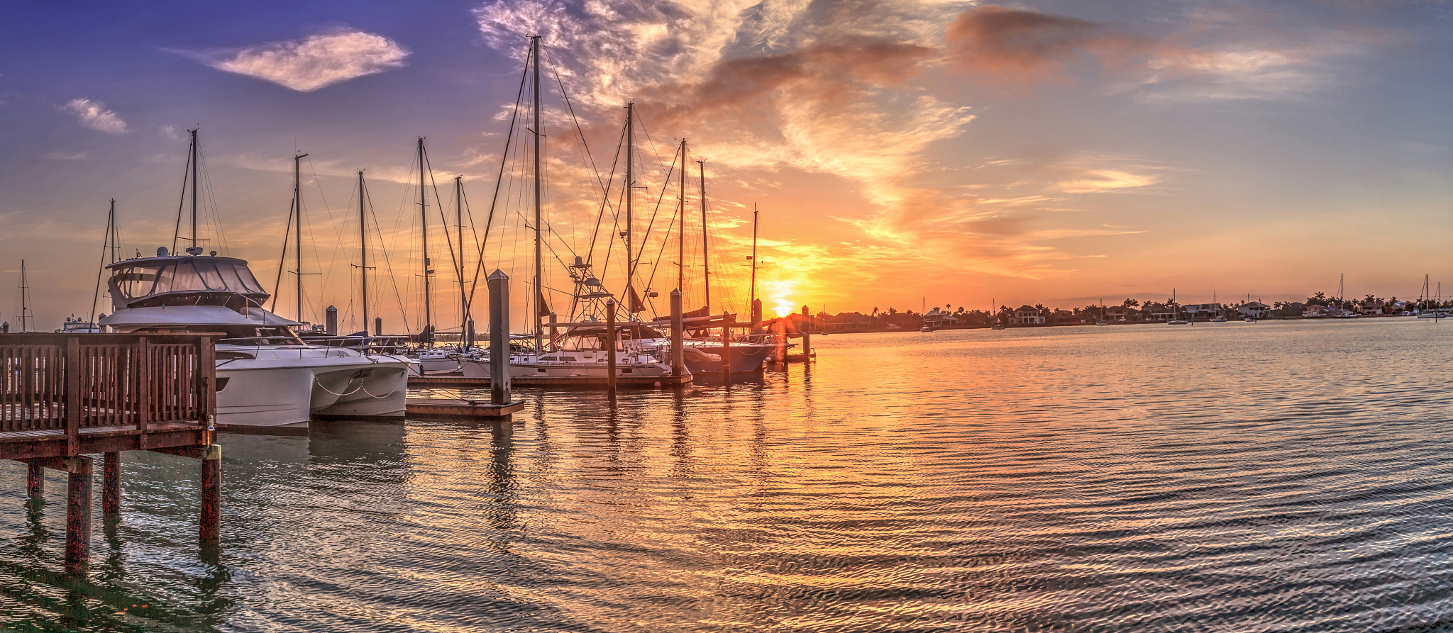 break of dawn sunrise over boats and sailboats at factory bay ma