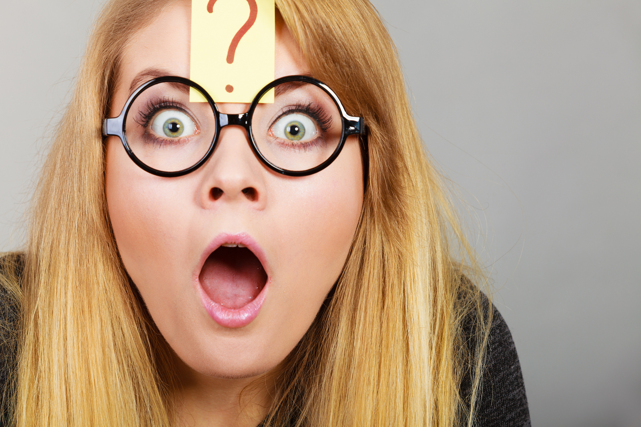 weirdo nerd woman having question mark on forehead