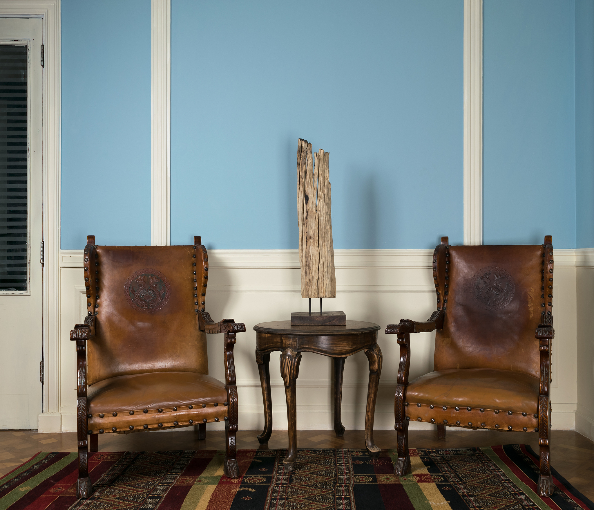 two wooden retro armchairs, table lamp and round coffee table