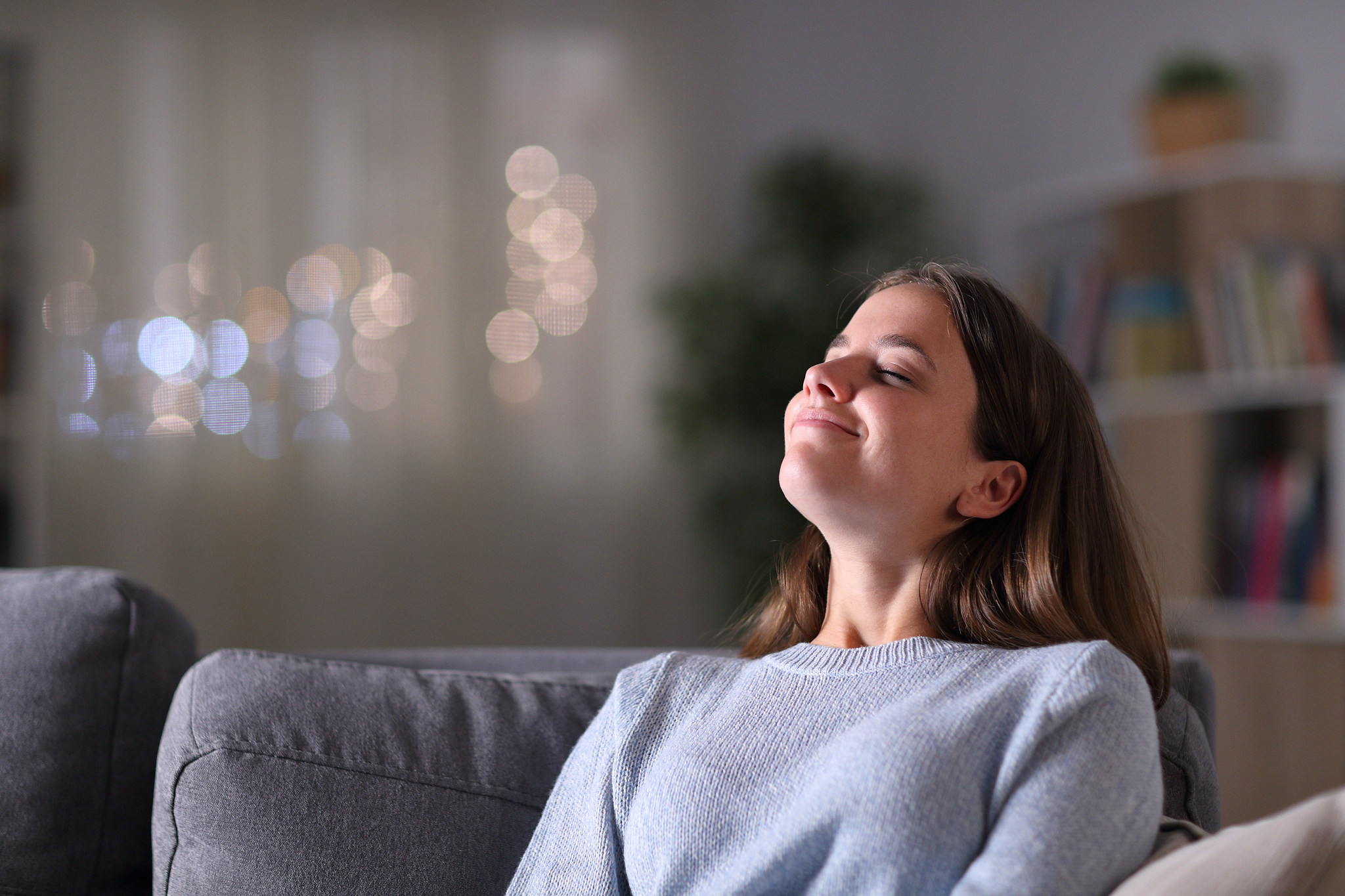 relaxed homeowner breathing deeply fresh air at home