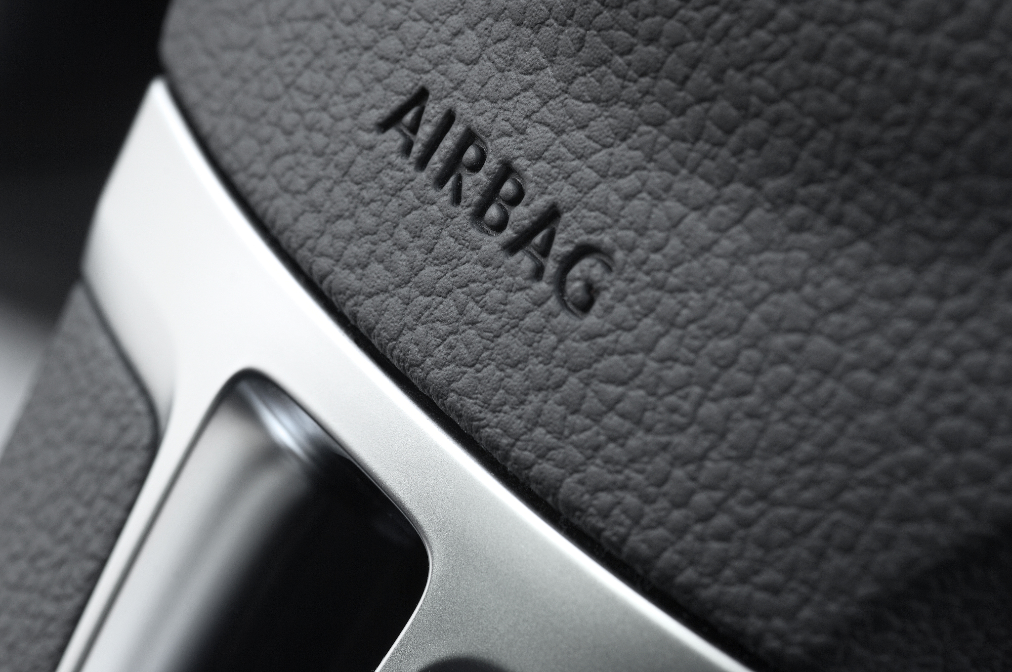 close up of a car steering wheel airbag