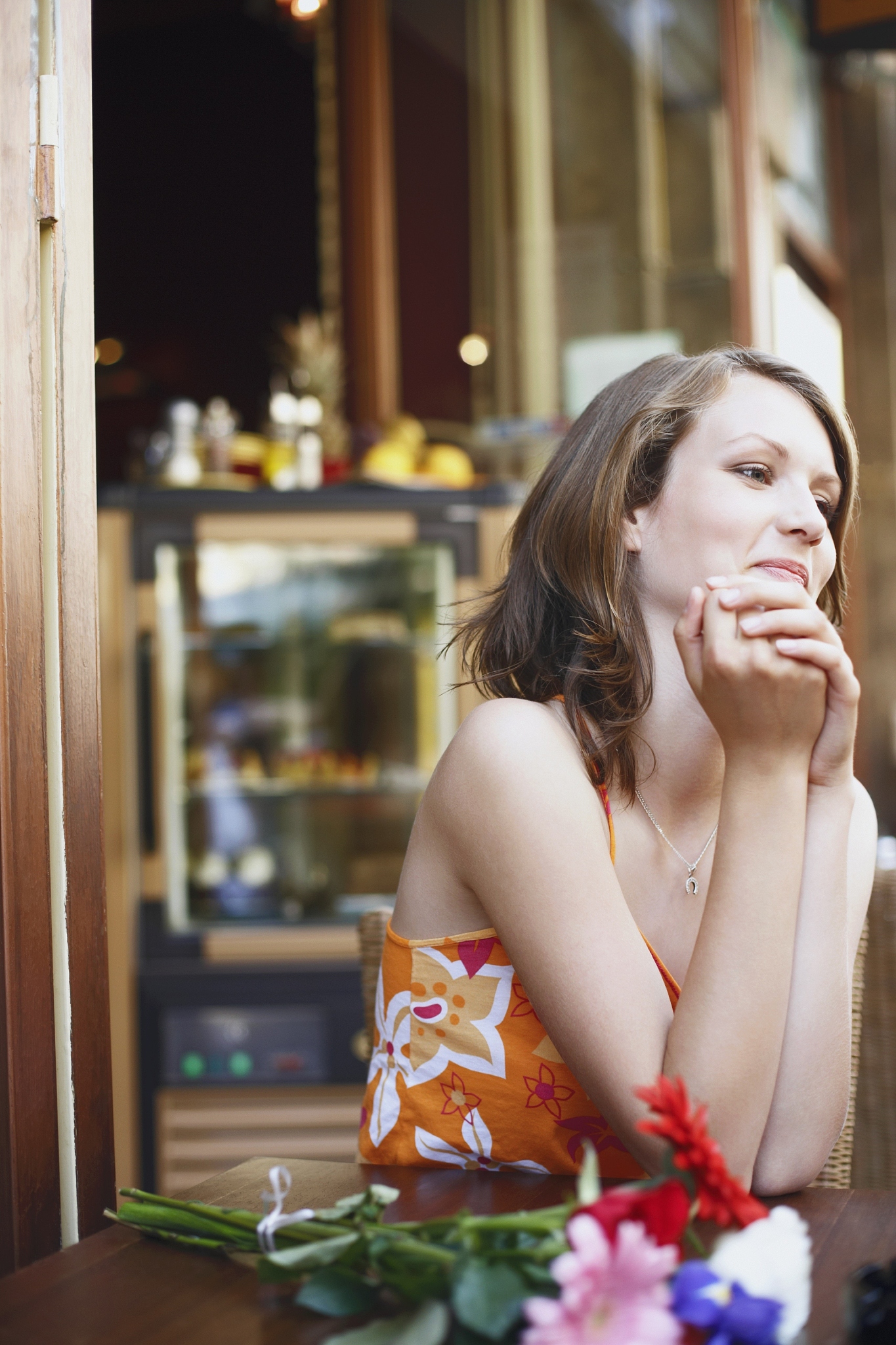 teenage girl seated at a table in a restaurant