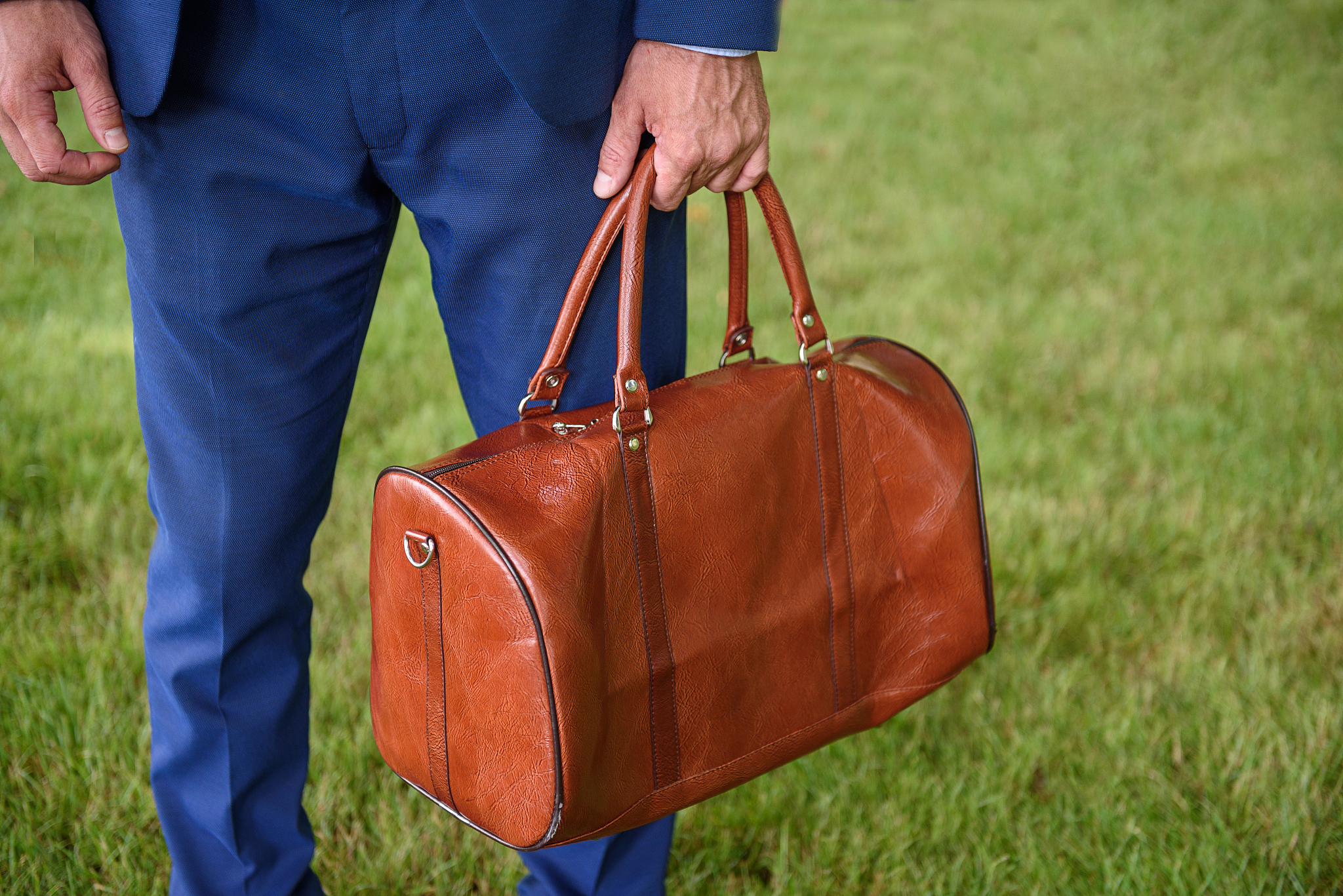 man in suit carrying suitcase