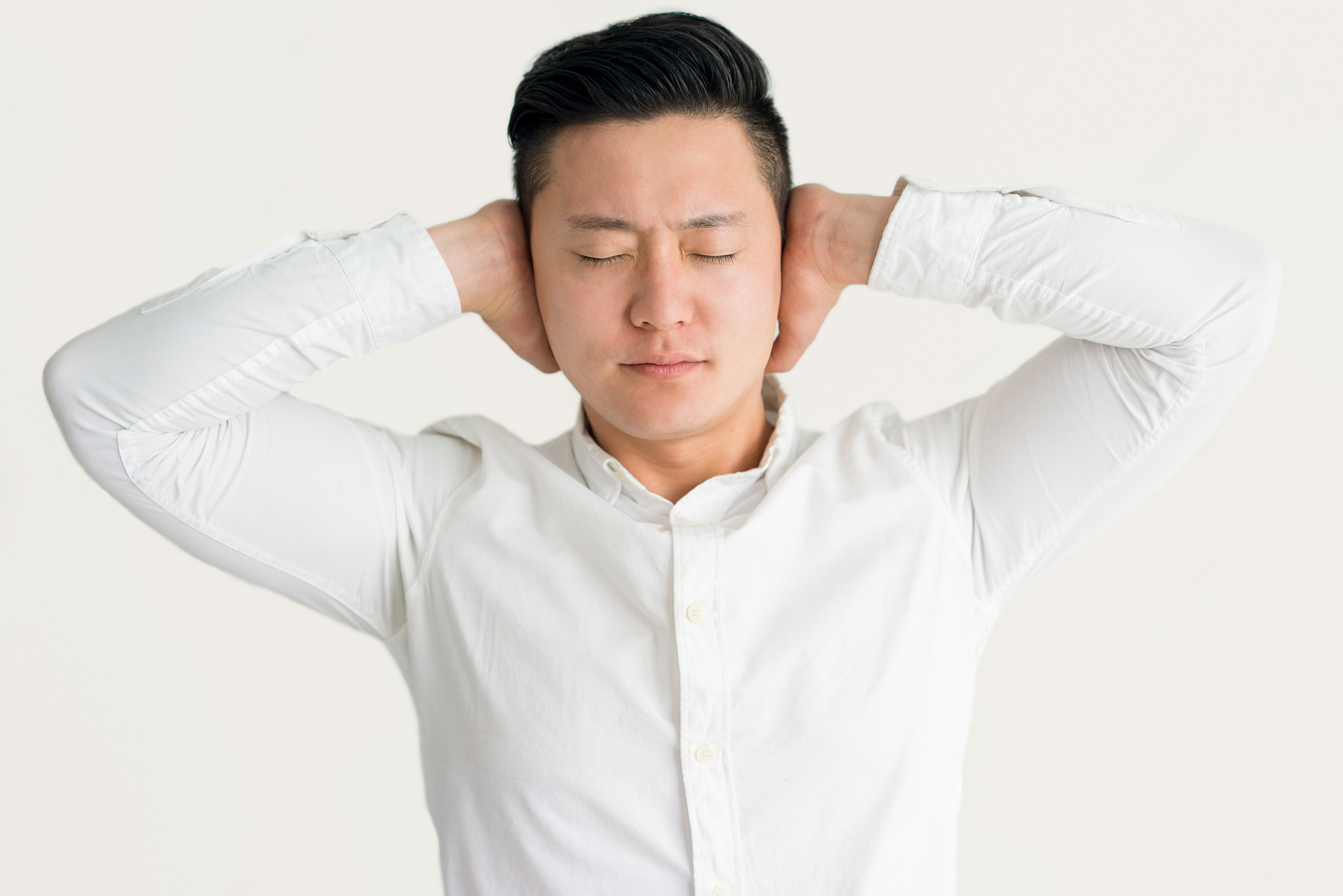 stressed asian man annoyed with noise