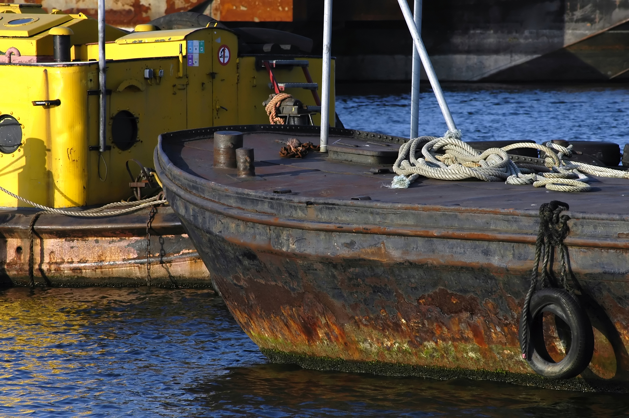 detail of an old & rusty cargo ship in harbour