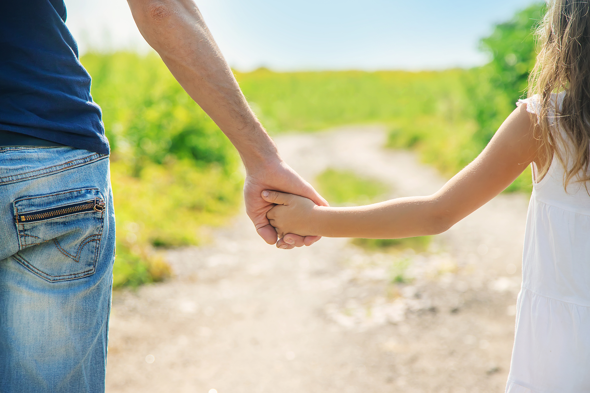 father and daughter walk holding hands. selective focus.