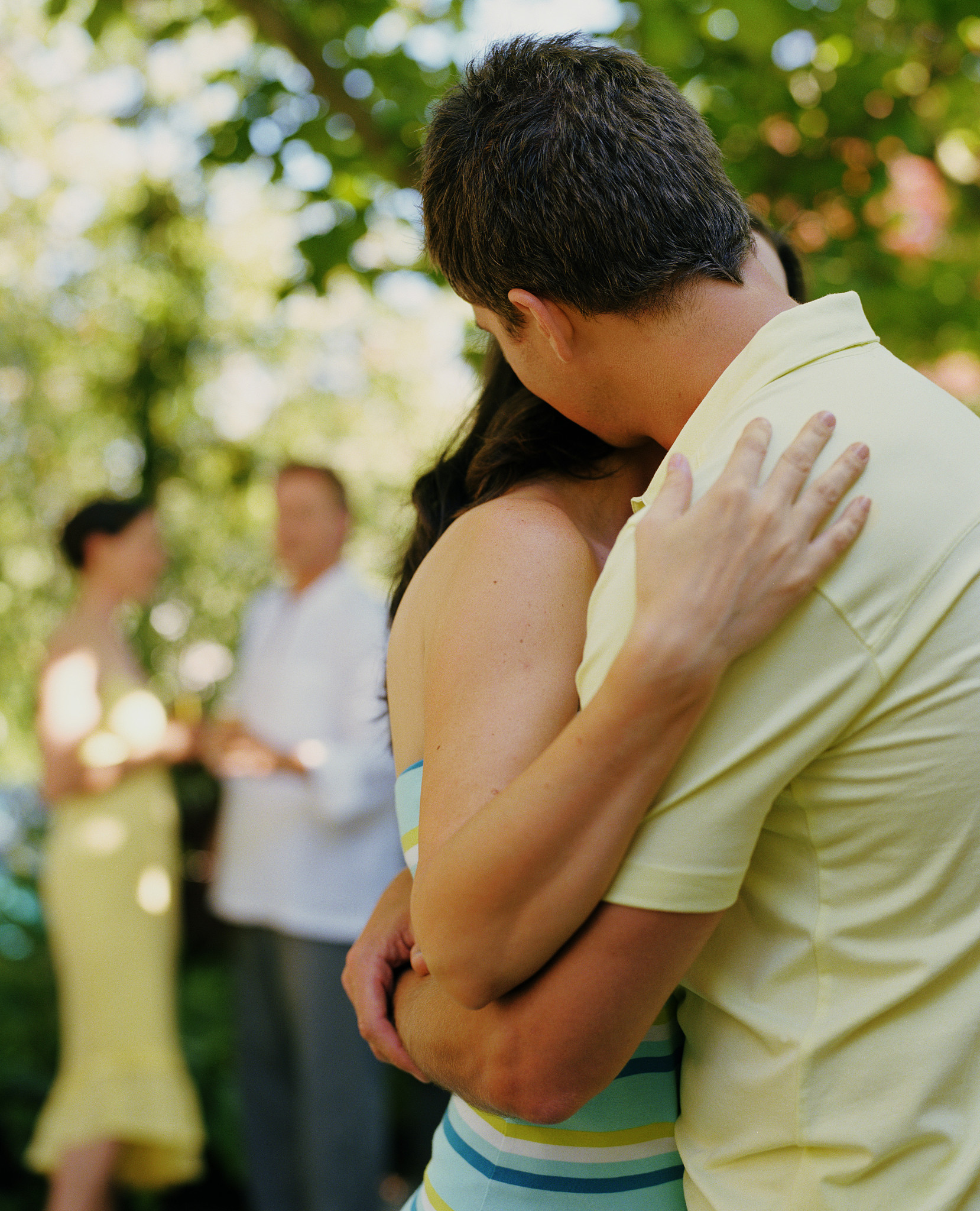 man and woman embracing, side view