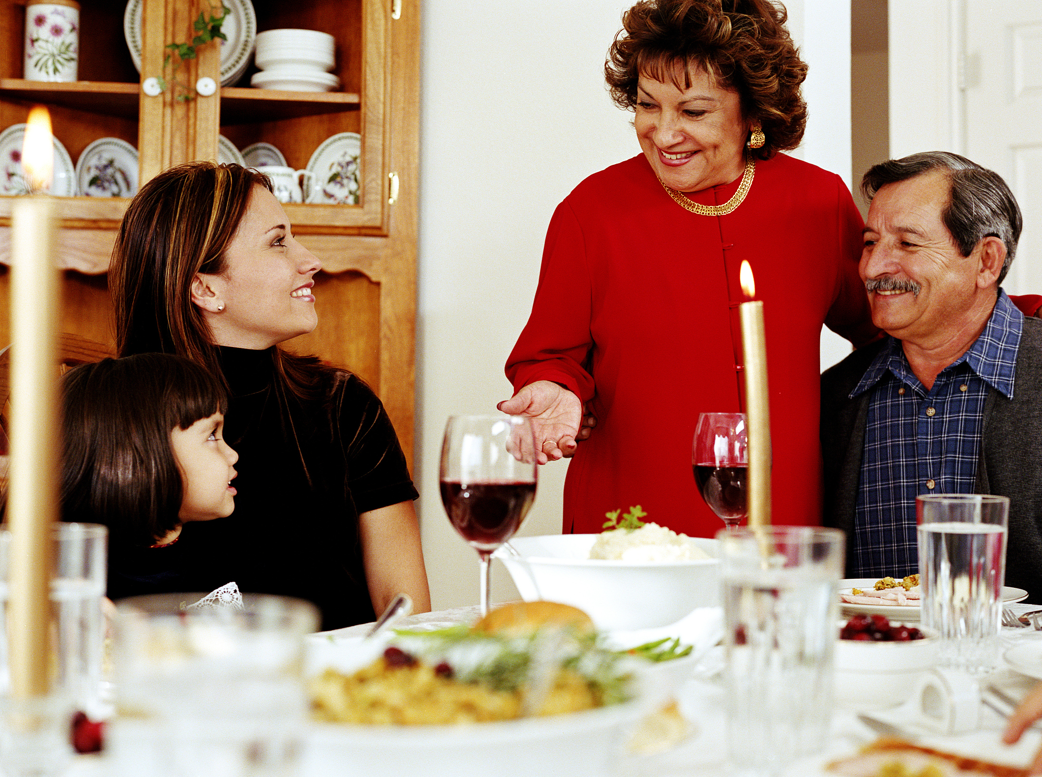 family at dinner table, smiling