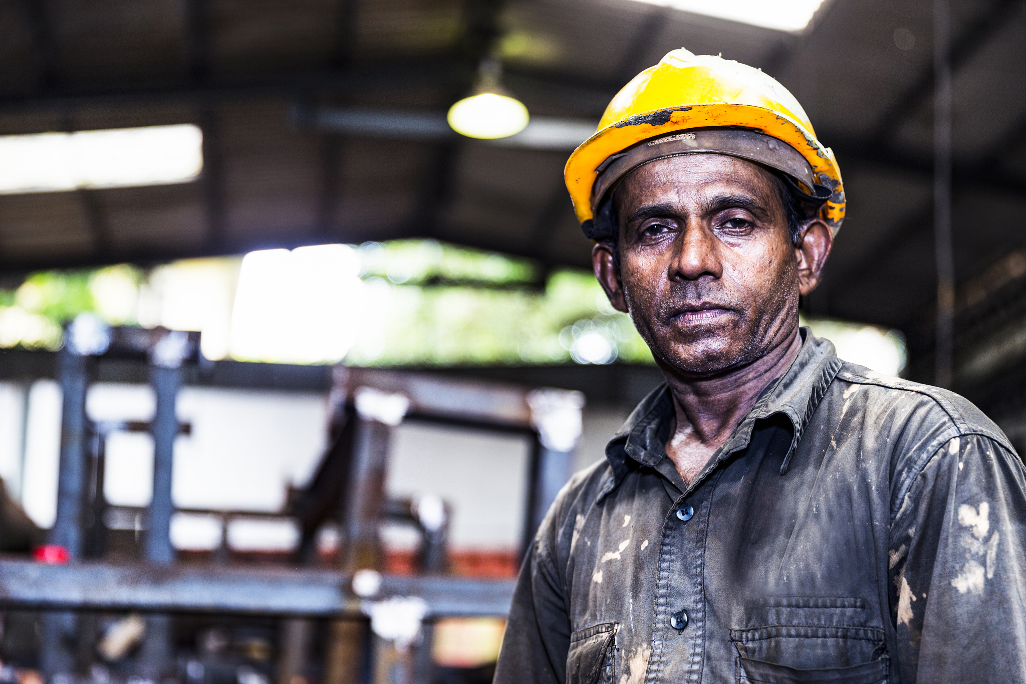 old factory employee looking at the camera