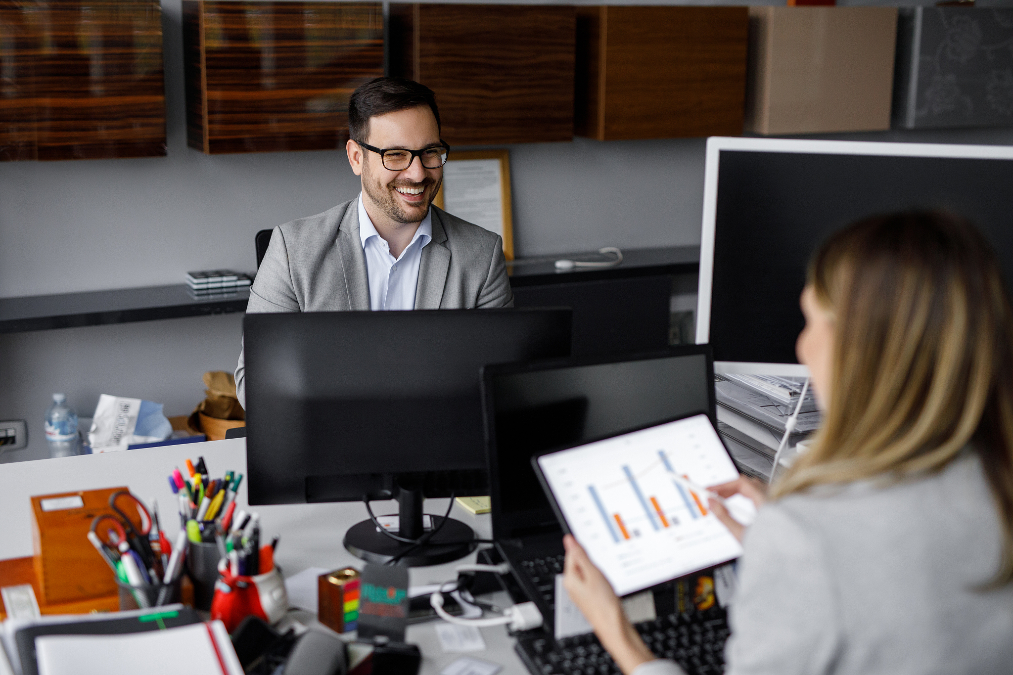 two business people working together in the office using compute