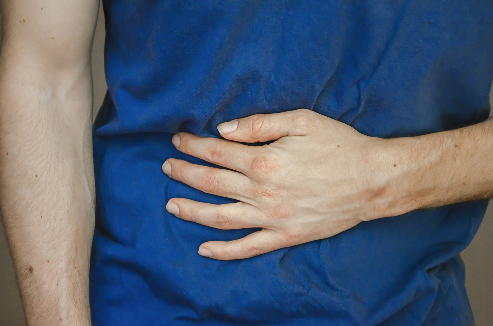 a man holding his stomach. close up.