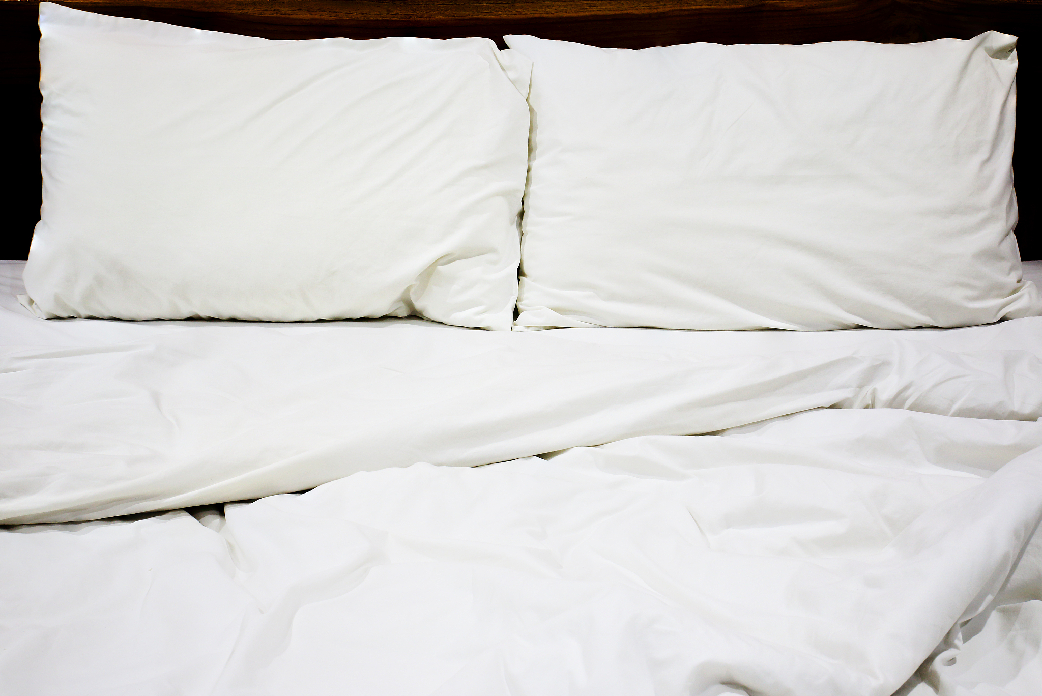 messy white bed and pillow, in the morning