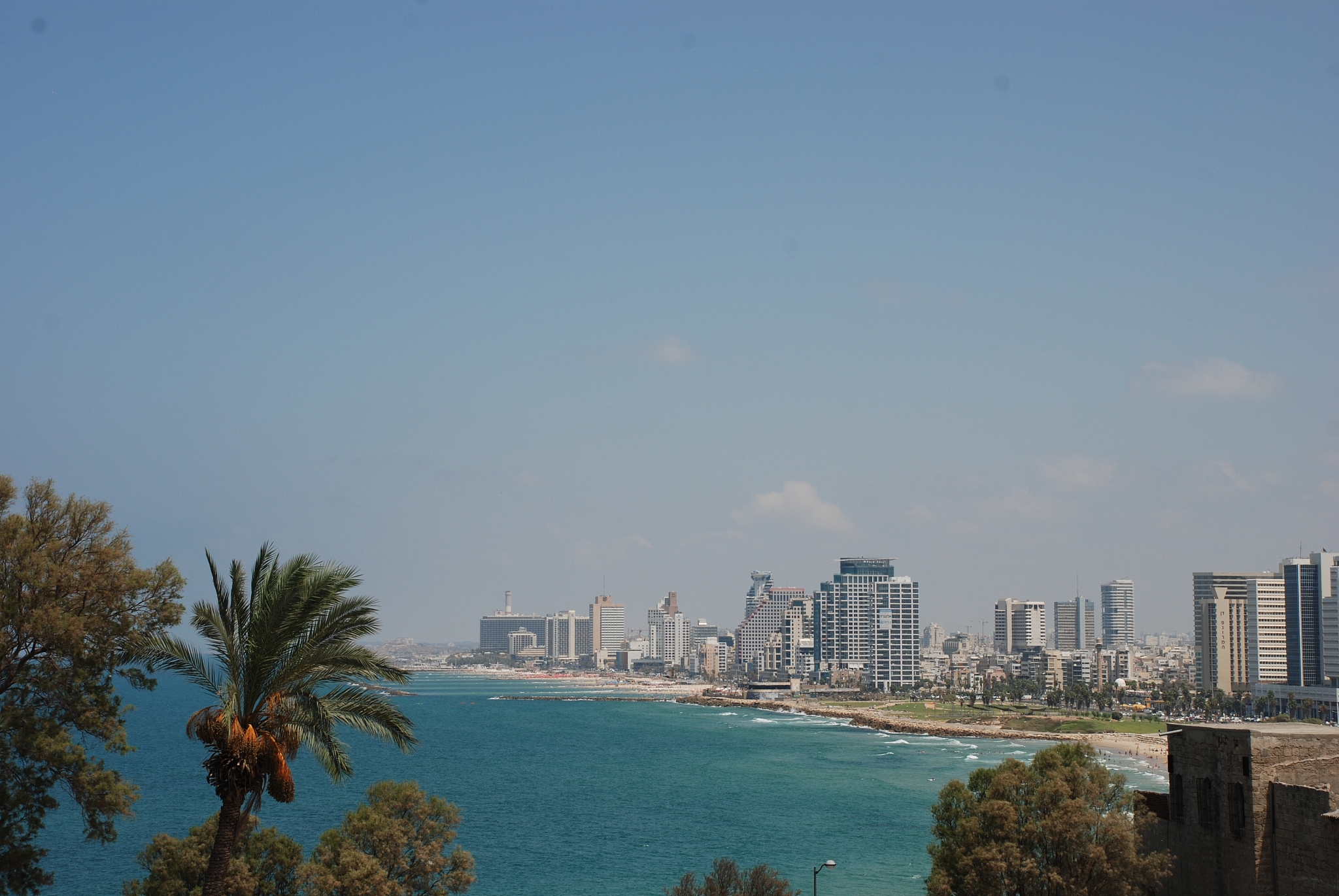 sea and city buildings against sky