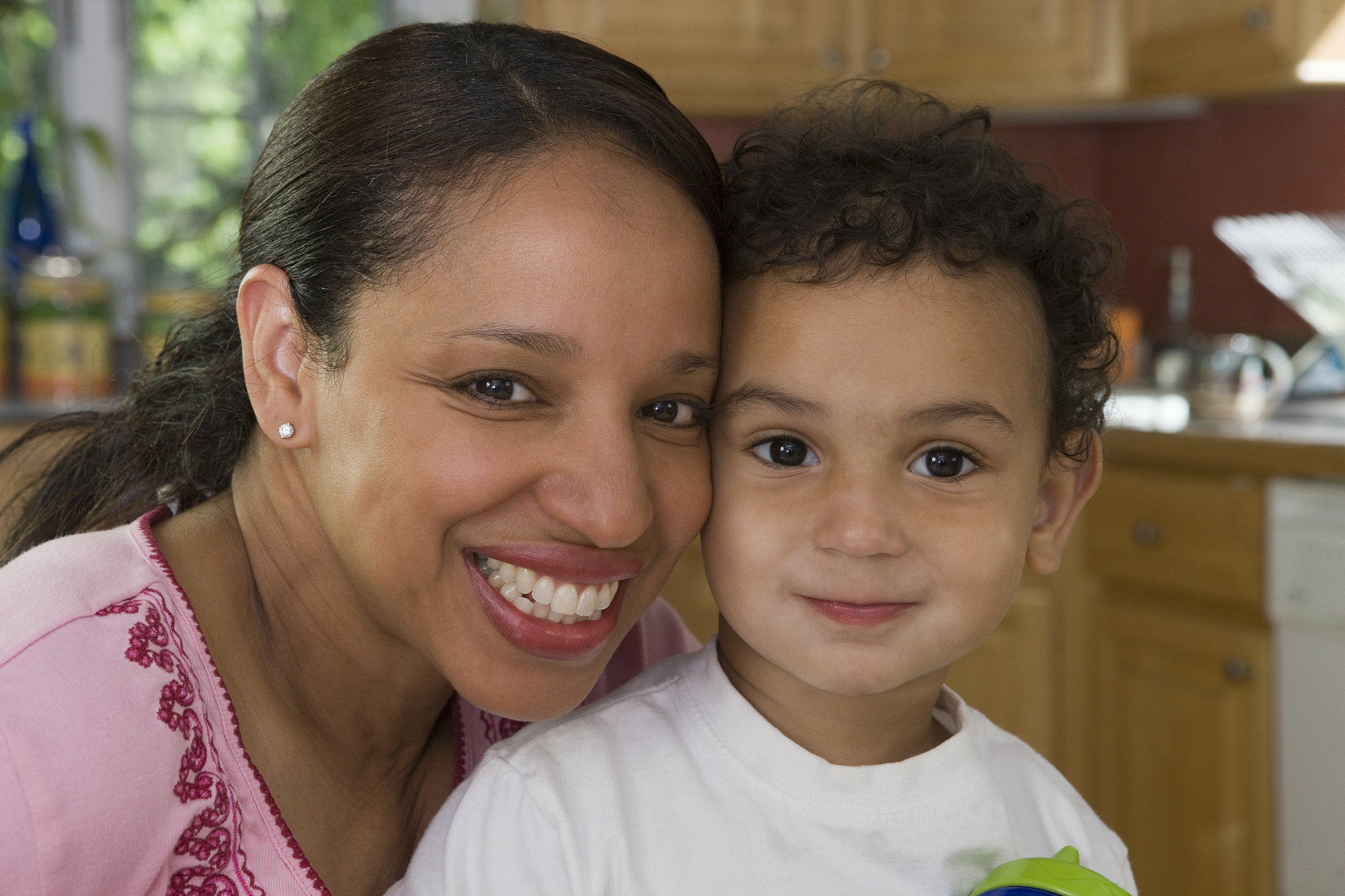 hispanic woman smiling with her son