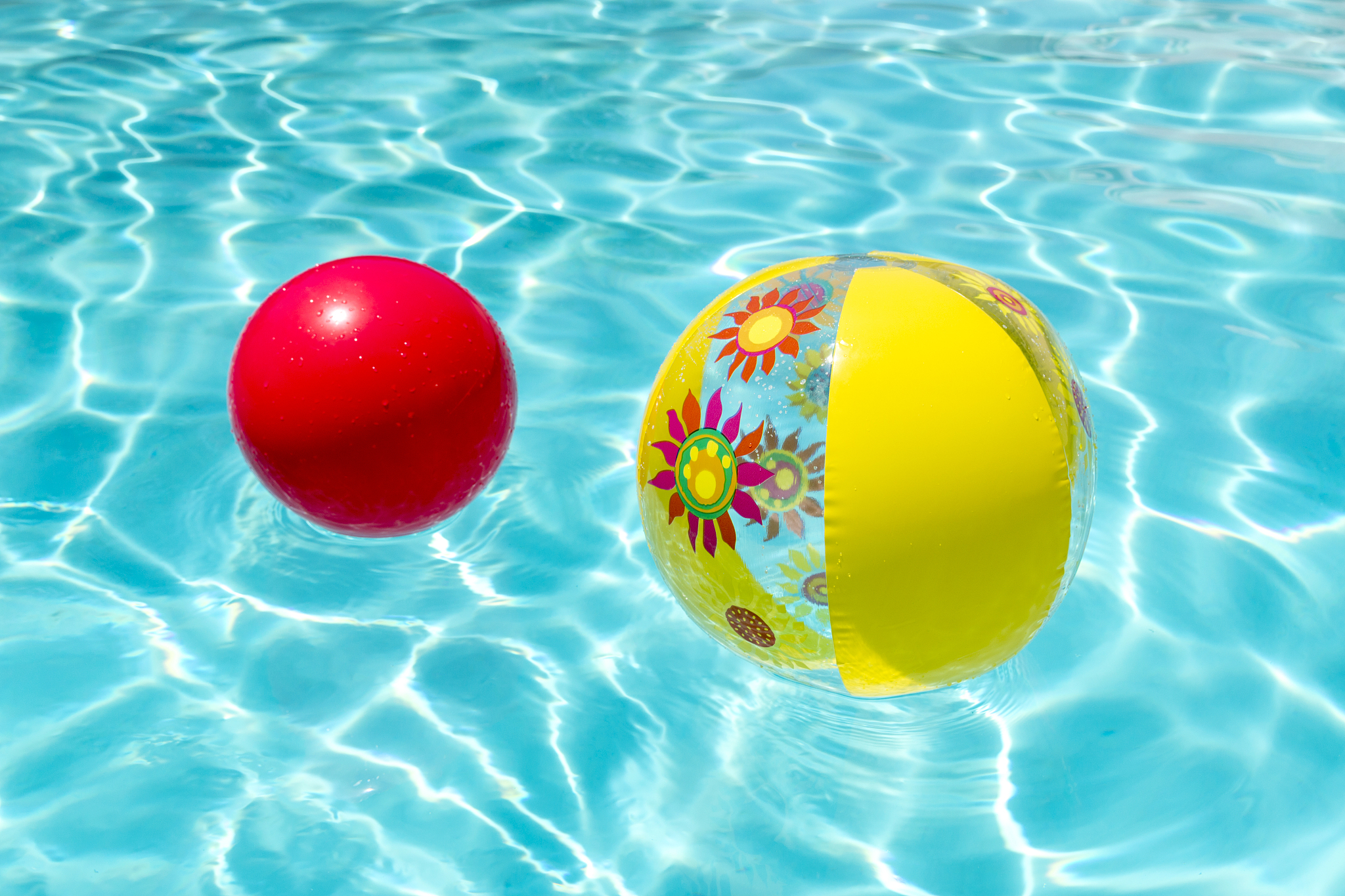 bright yellow flower beachball and red ball on the surface of cr