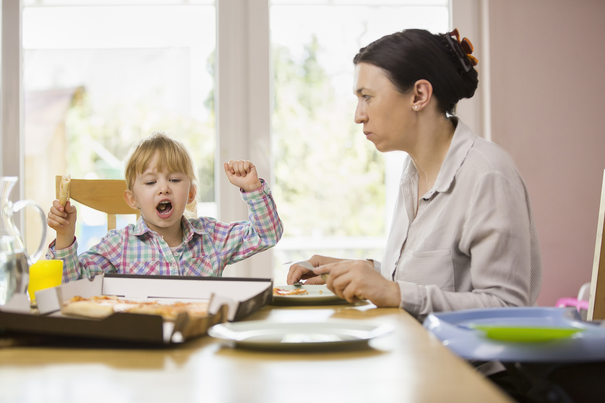family eating pizza at home out of pizza box