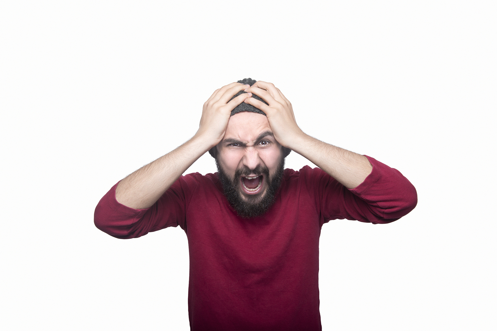 portrait of an angry man screaming in front of a white backgroun