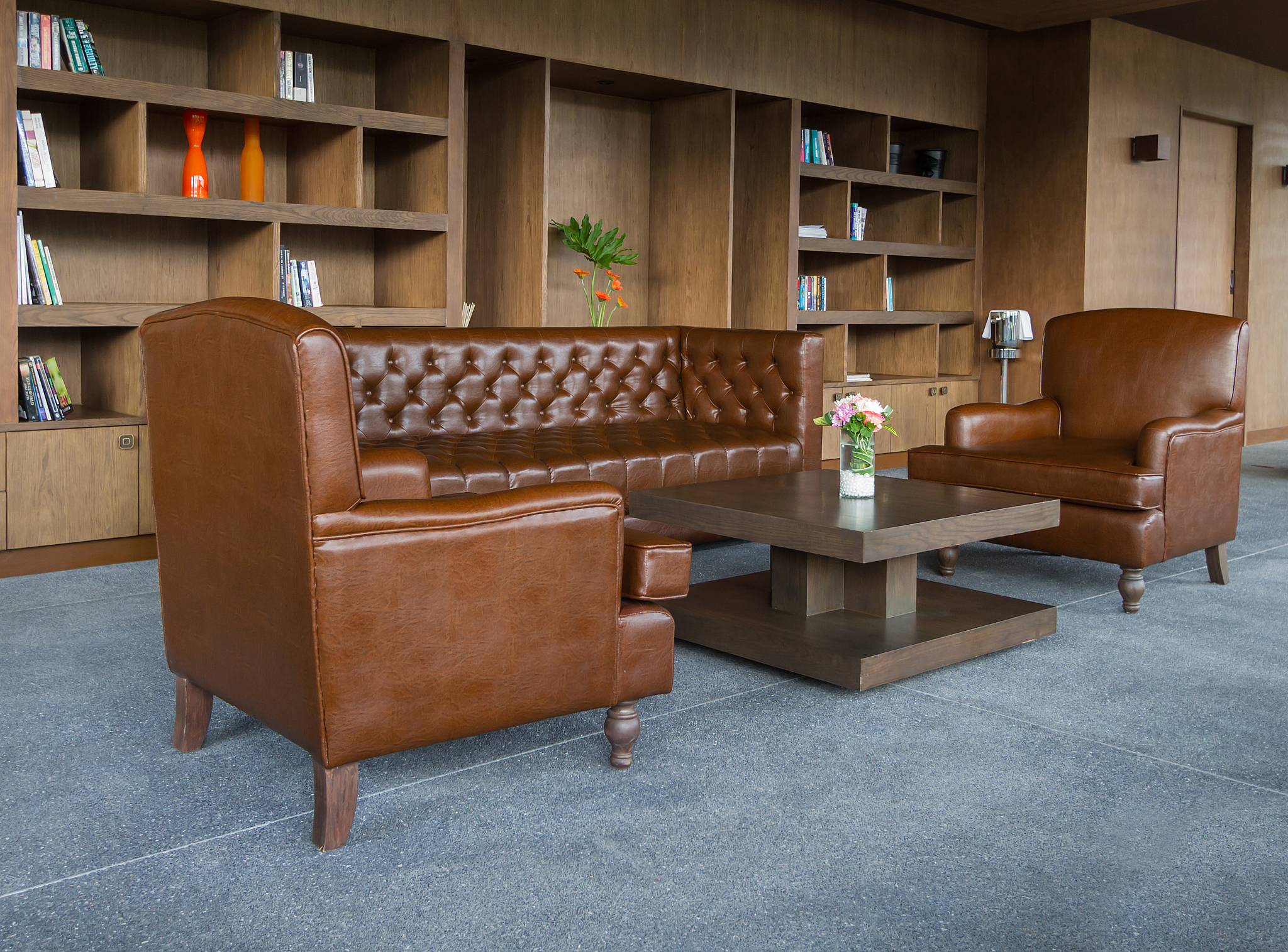 room with leather sofa and bookshelf