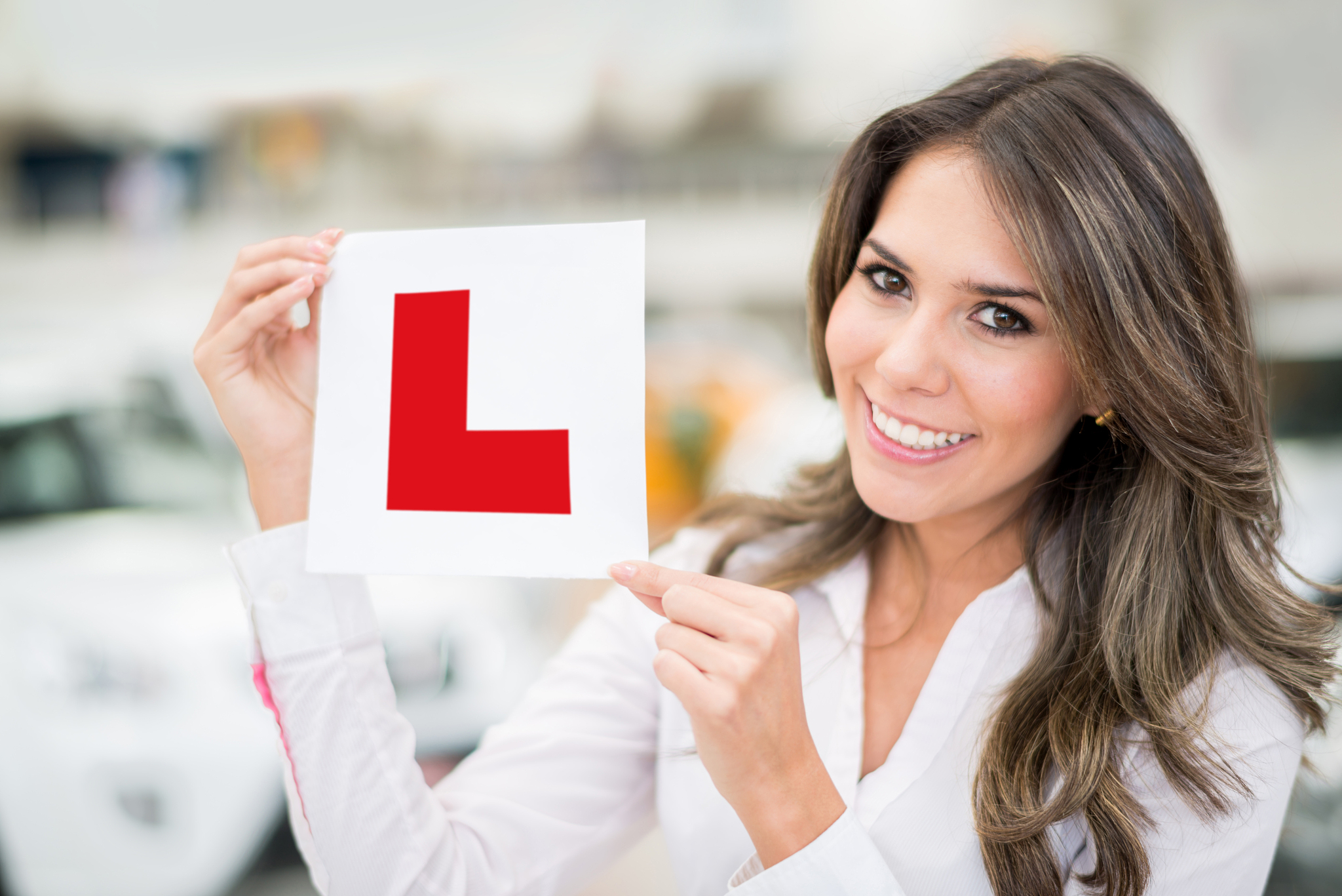 woman holding a learning sign