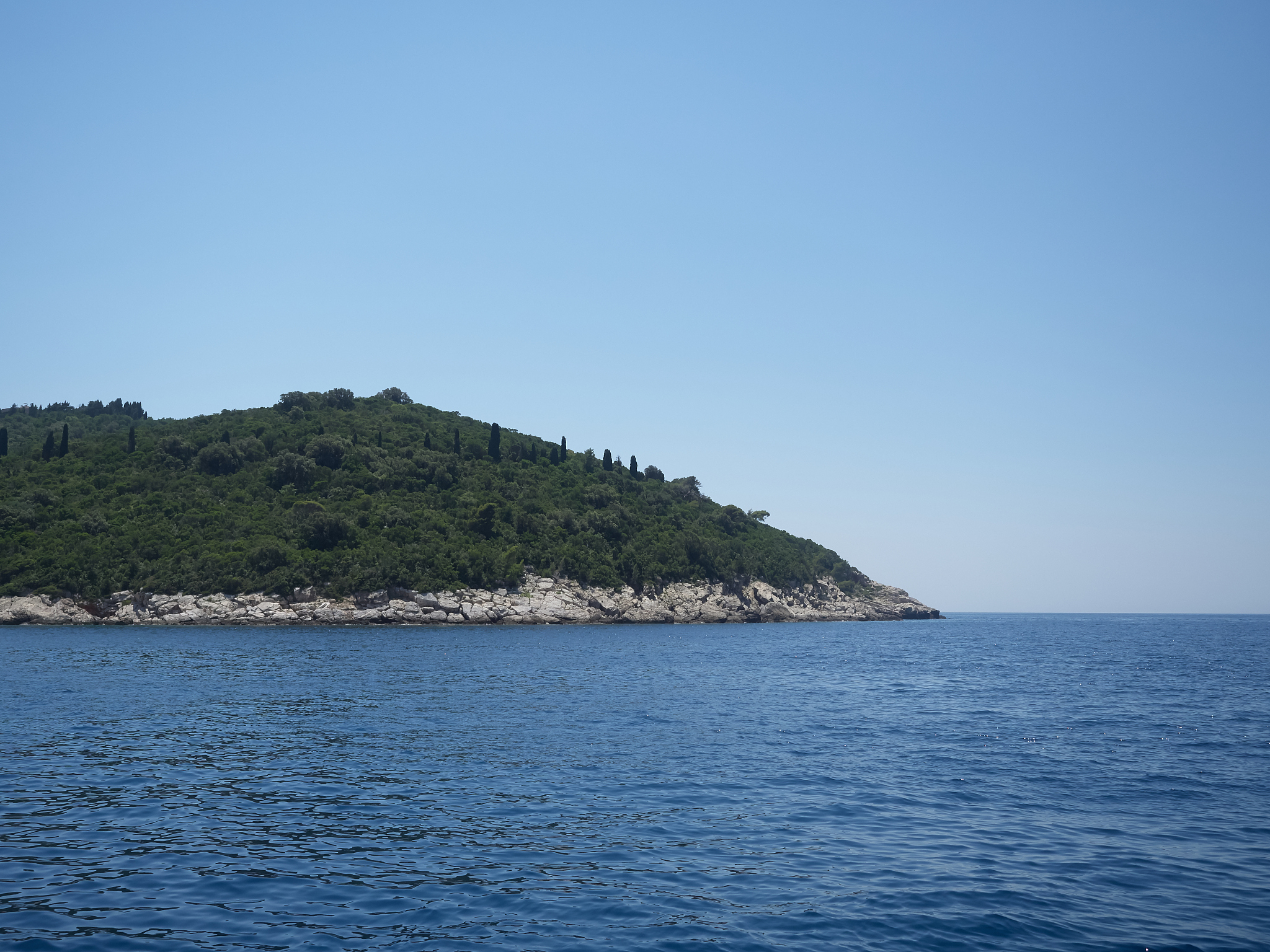 view of lokrum island during a boat trip in a sunny summer day. 
