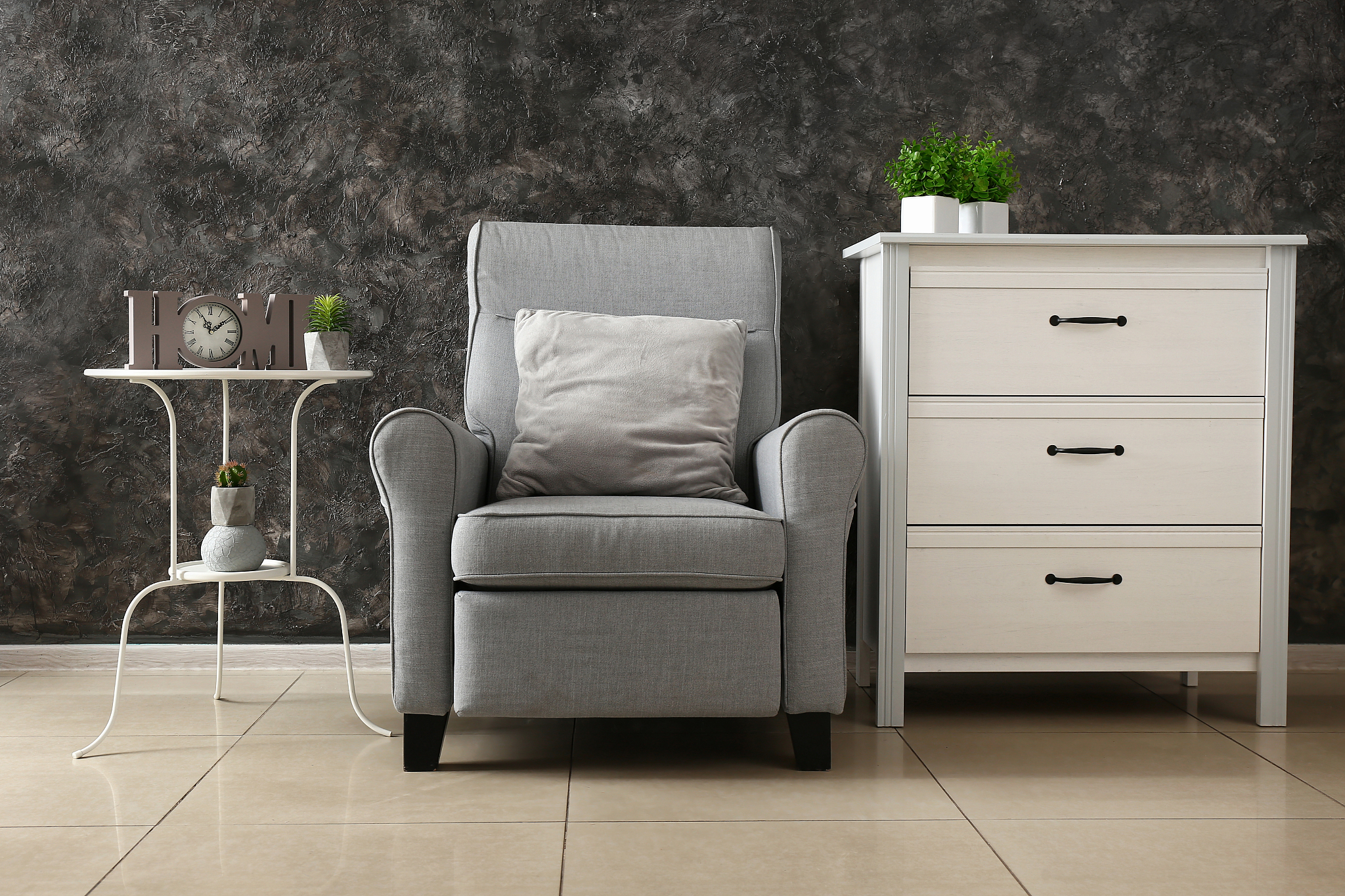 soft armchair with furniture near grunge wall in living room