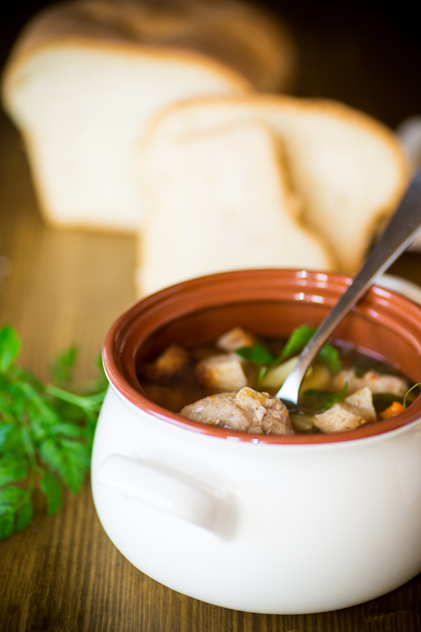 vegetable soup with beans and meatballs in a ceramic bowl