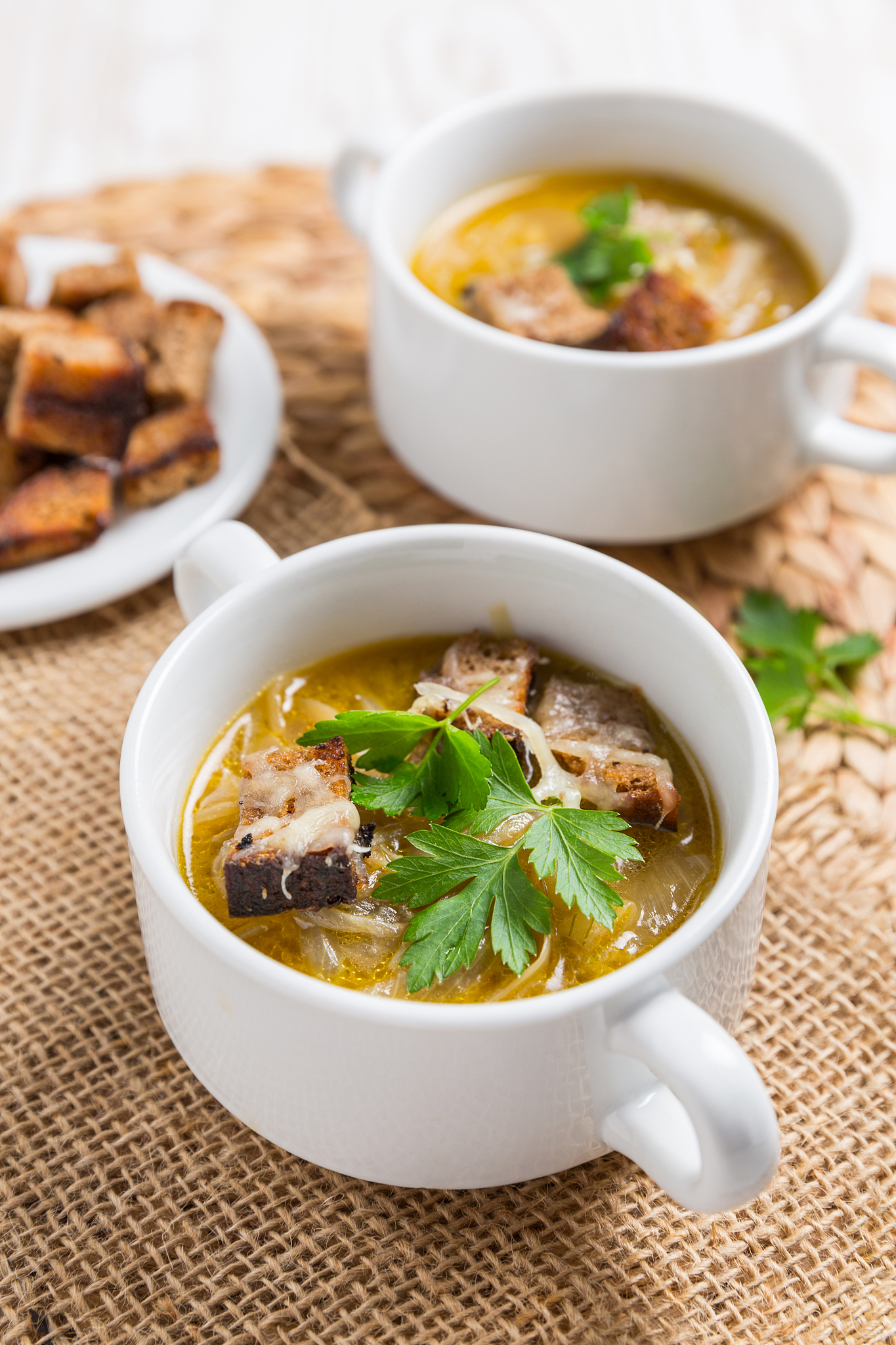 traditional french onion soup with toasted bread croutons for au