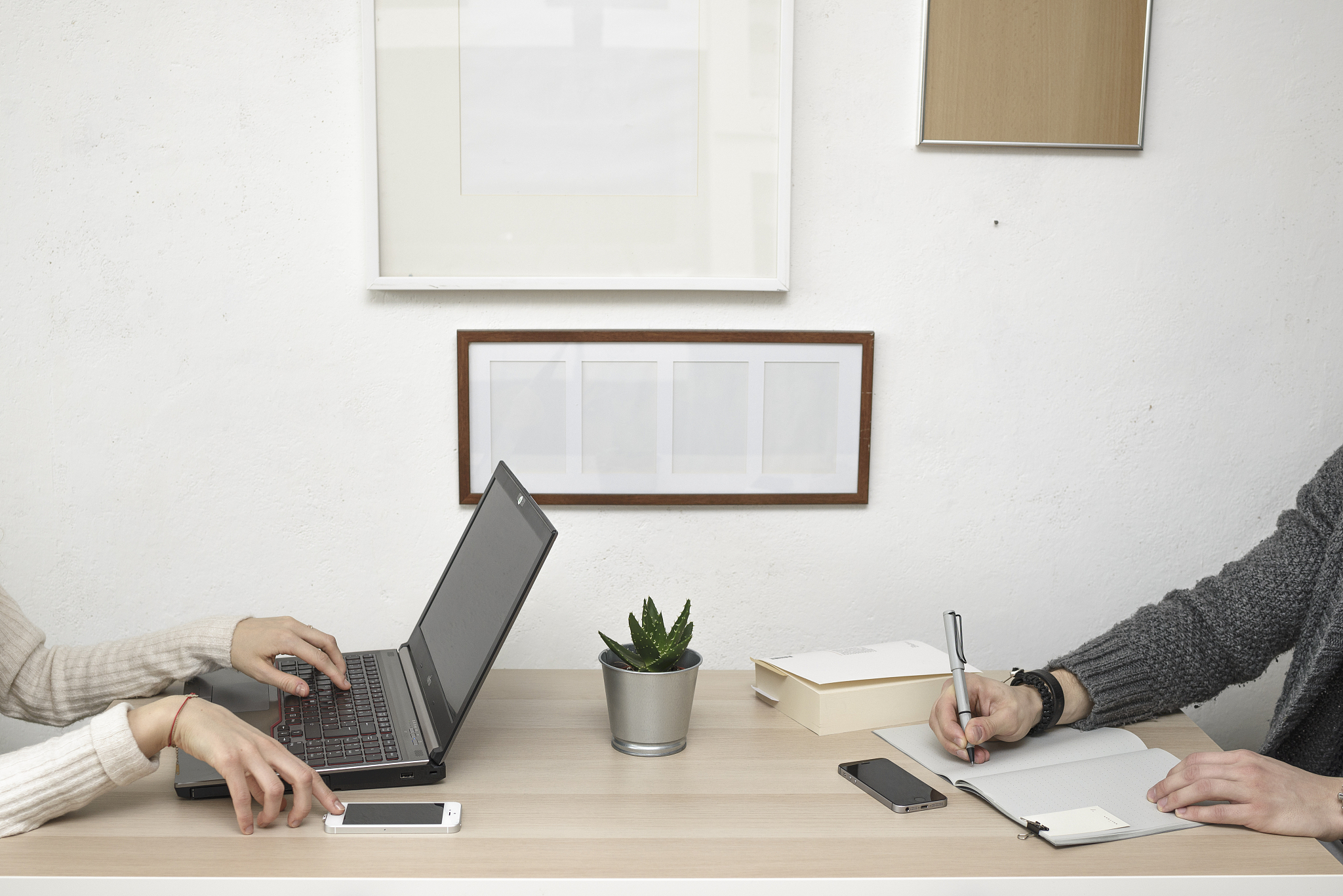 cropped hands of business coworkers working at desk in office