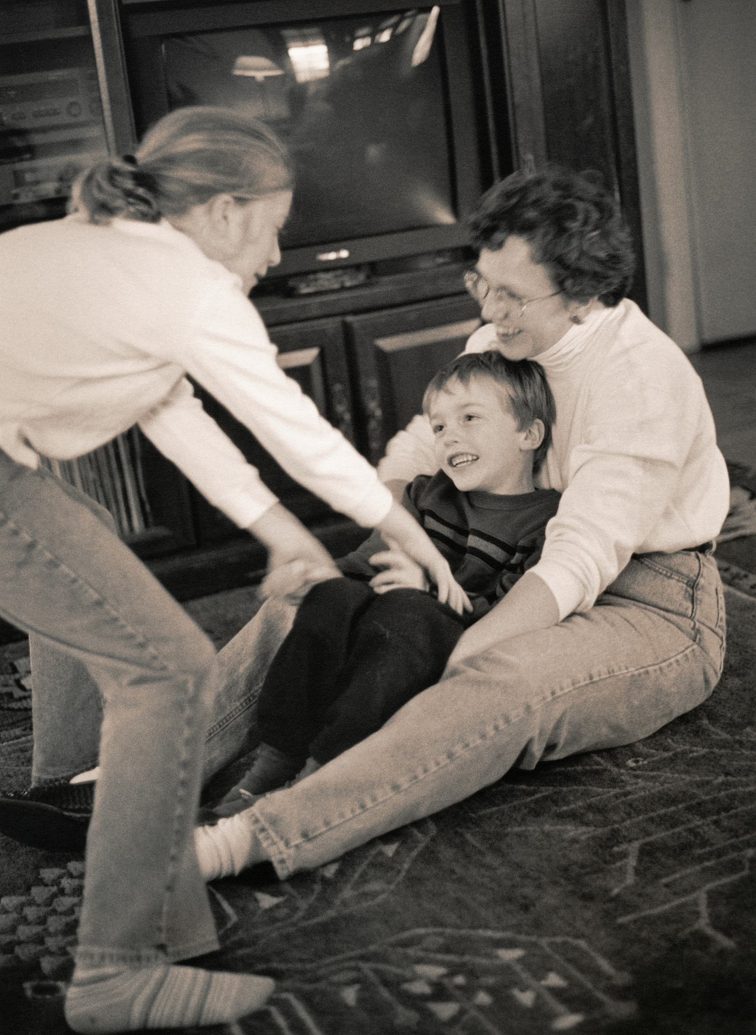 mother and children playing in living room