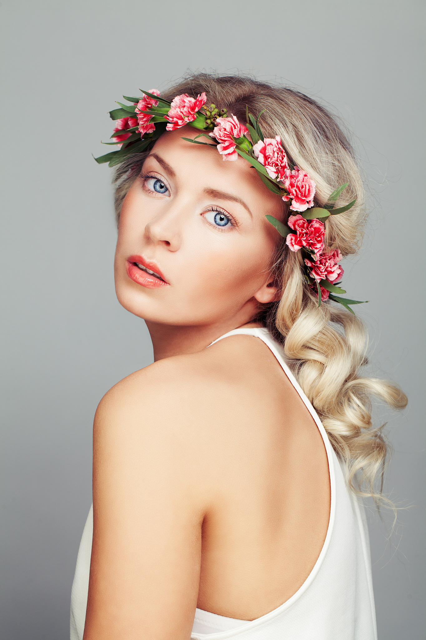 beautiful woman with flowers wreath. blonde curly hair and fashi