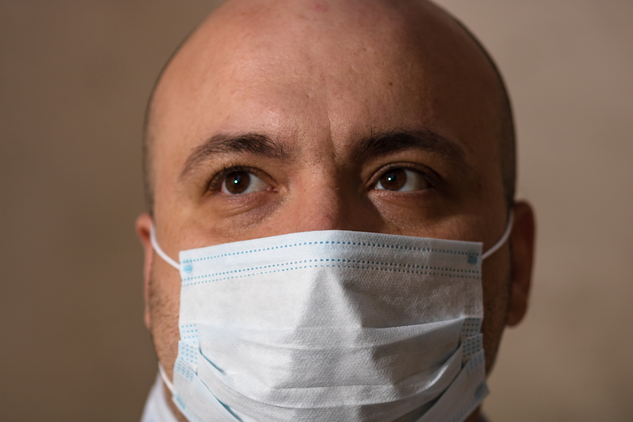 sick young man with medical protective face mask illustrates pan