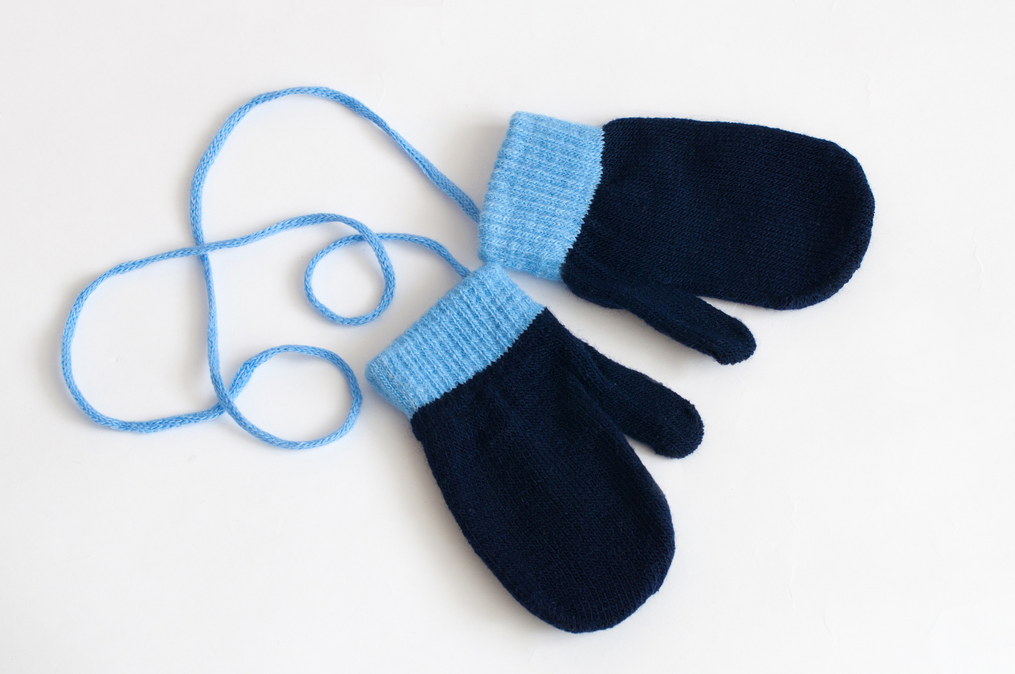 blue knitted mittens on a white background