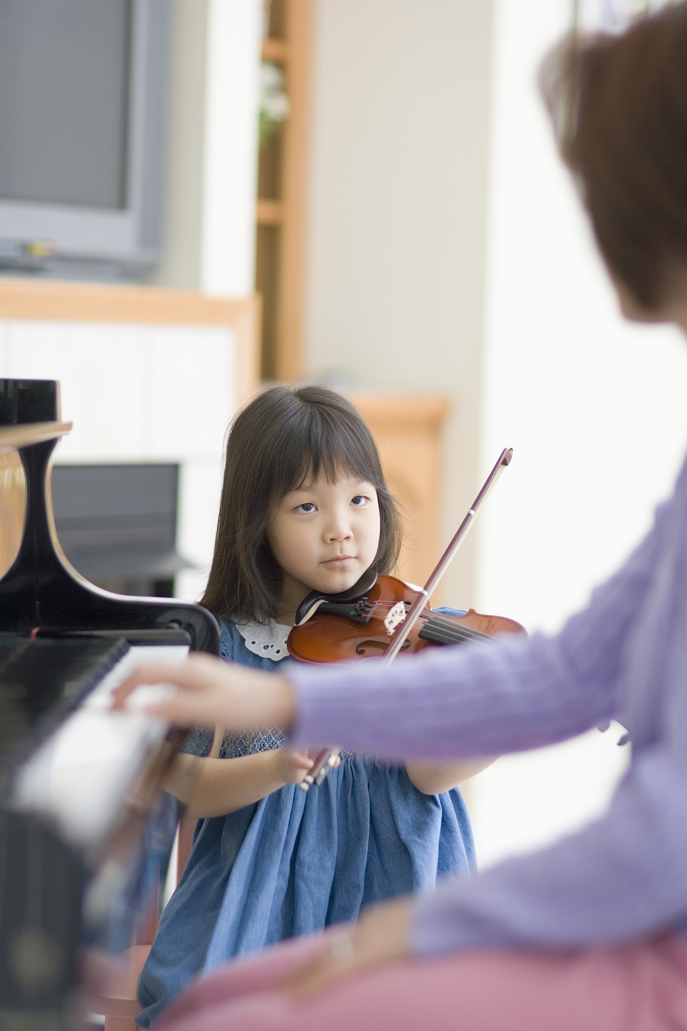 mother teaching daughter music