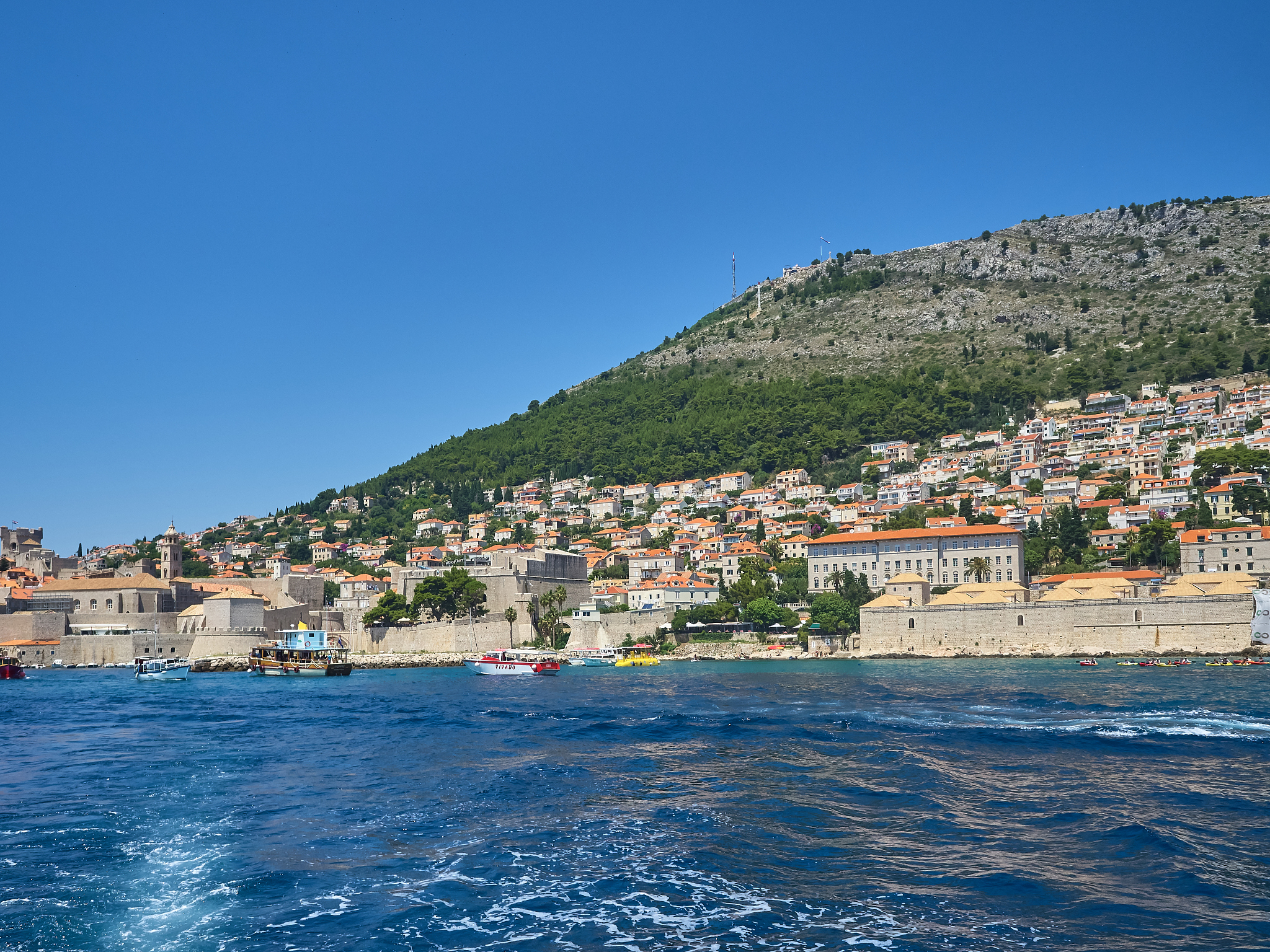 view of dubrovnik old town during a boat tour in a sunny summer 