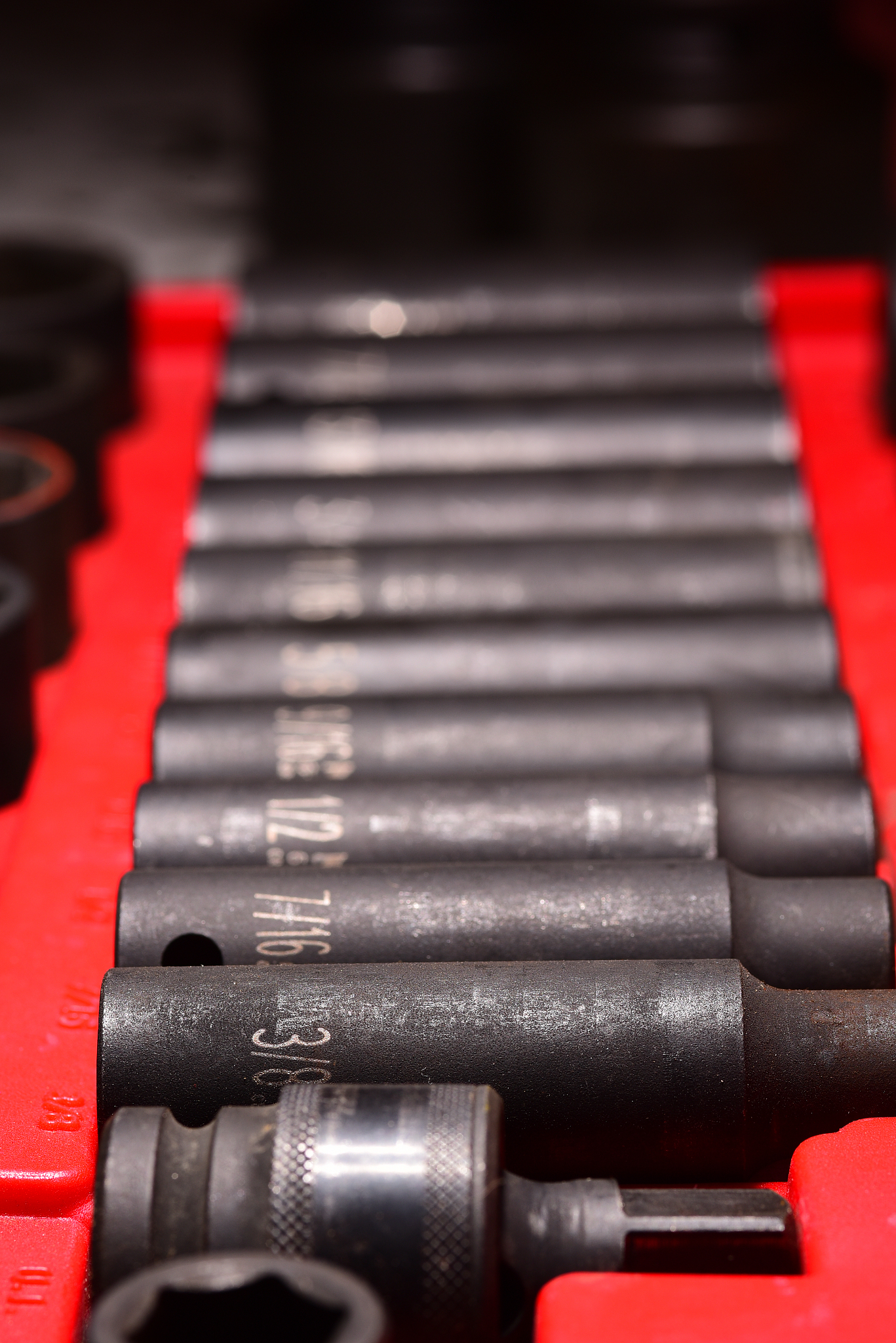 low angle view along impact tool socket set with inch measuremen