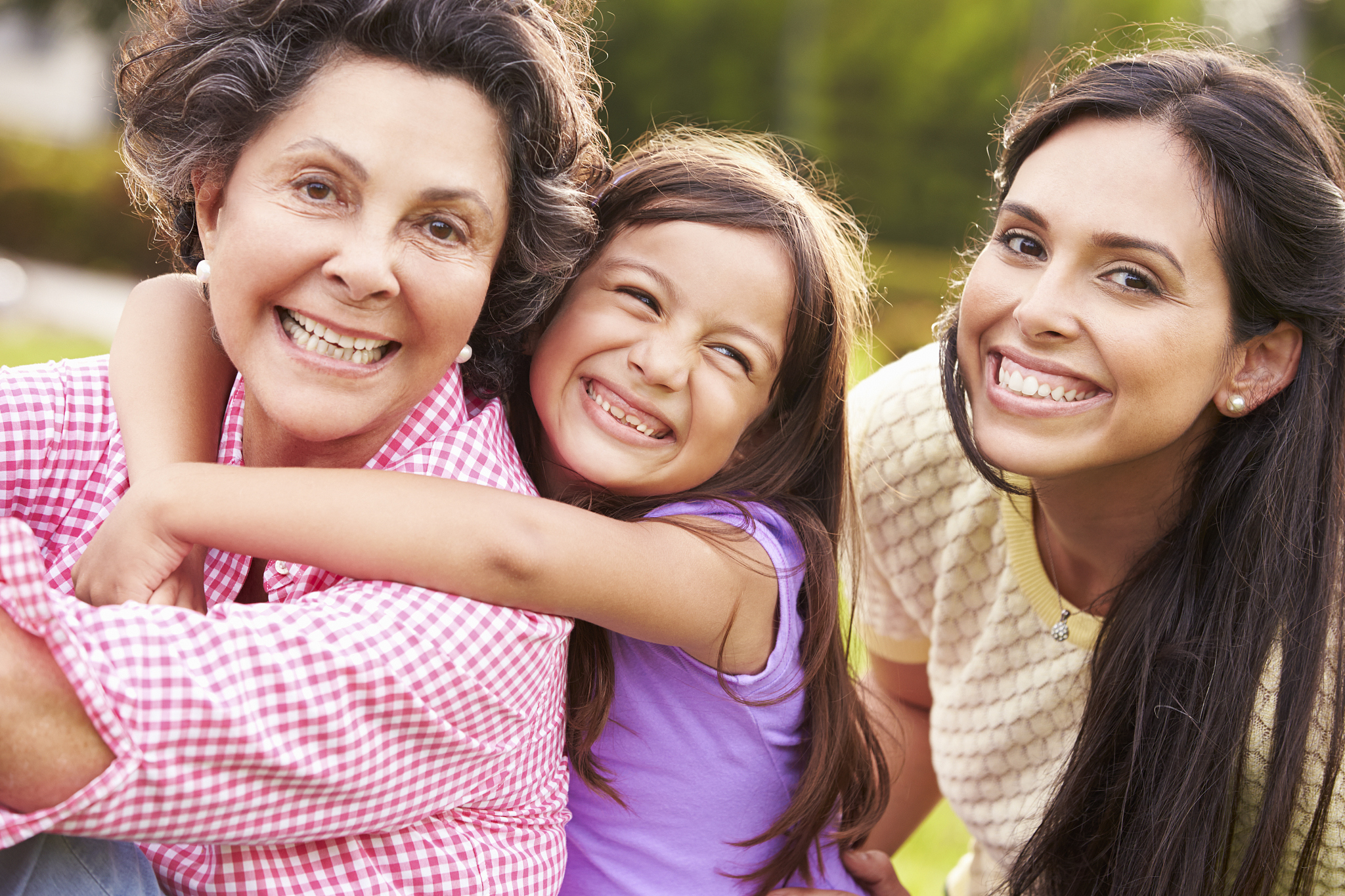 grandmother with granddaughter and mother in park