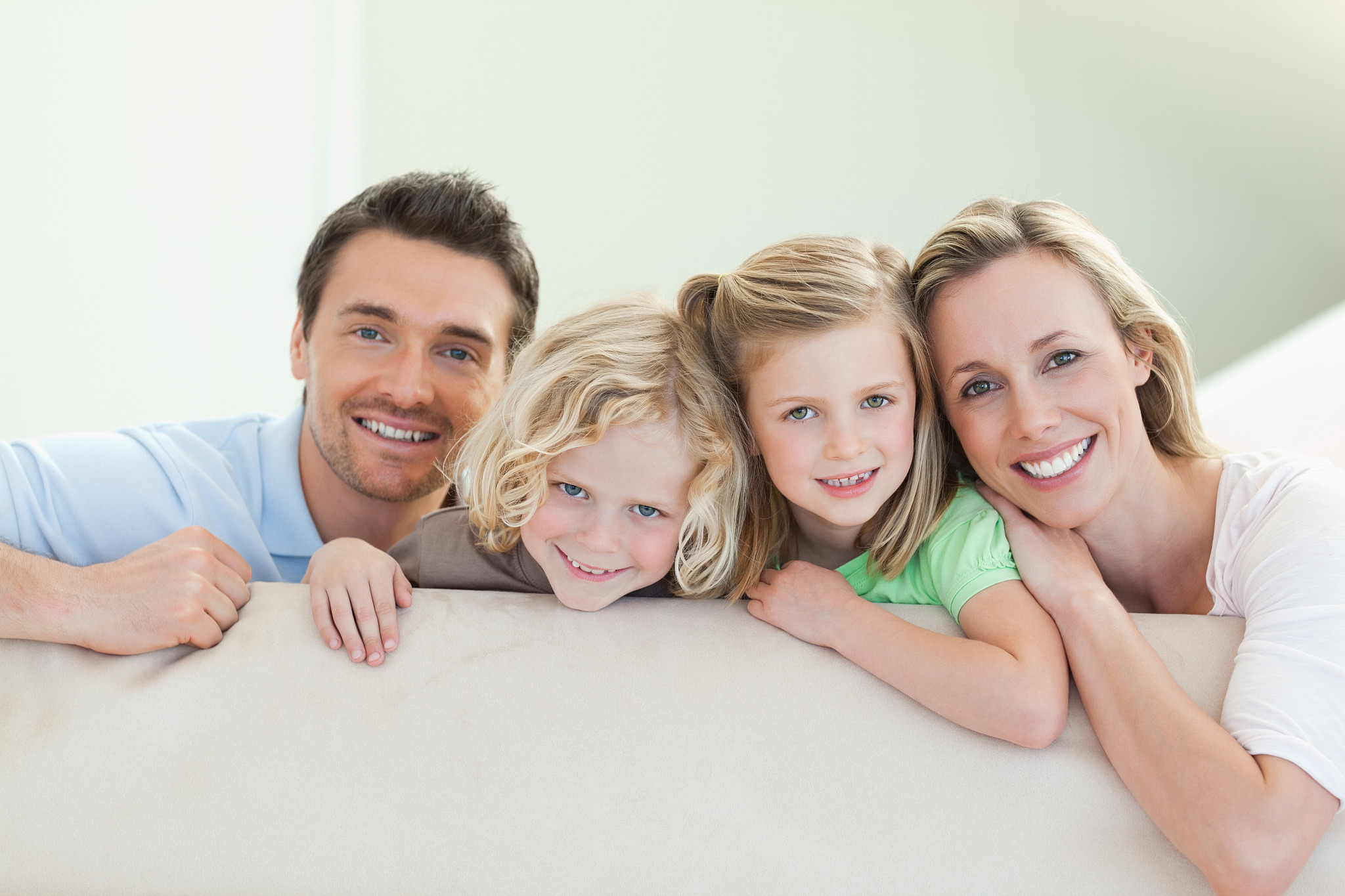 smiling family together on the couch