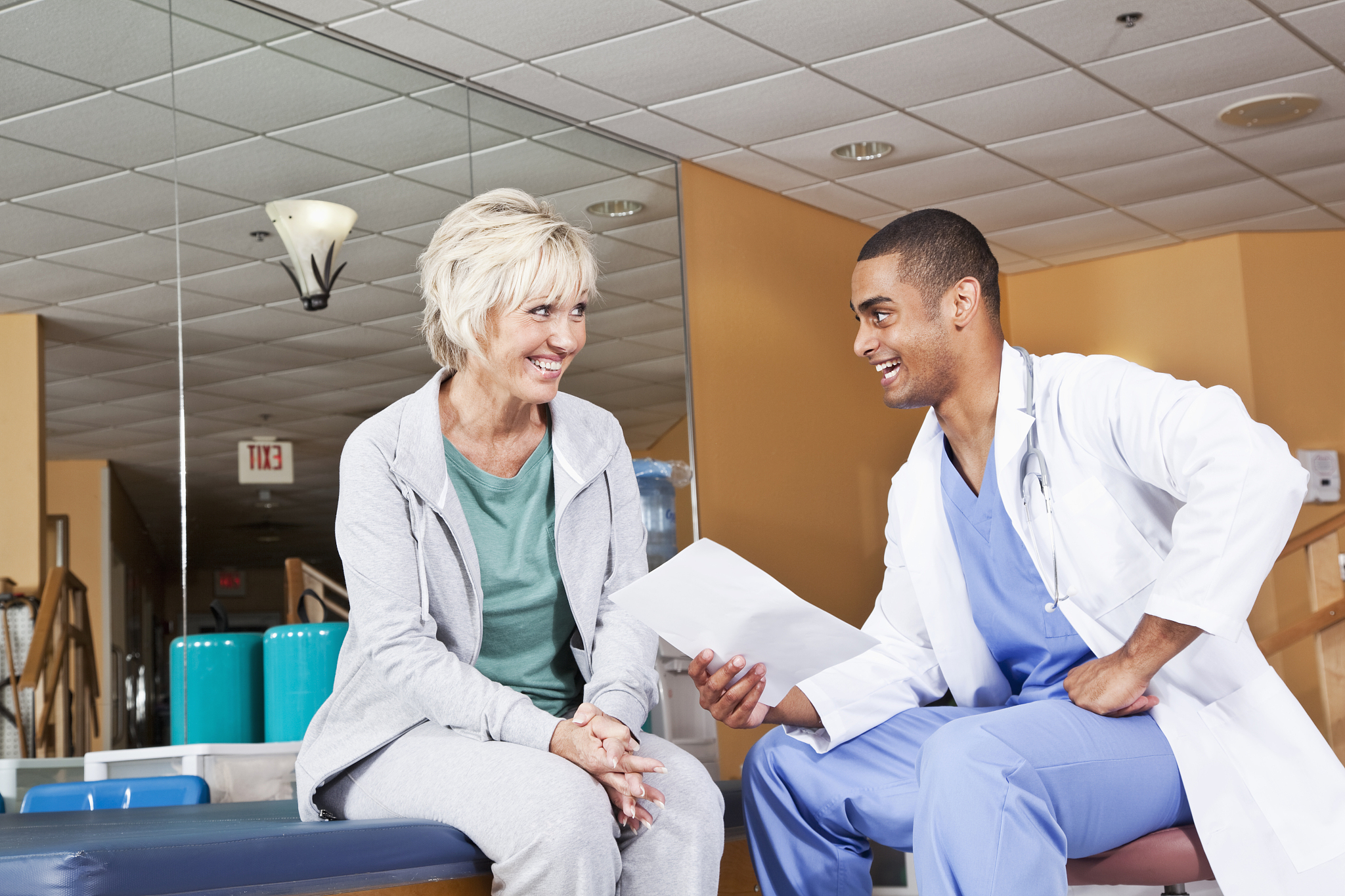 mature woman talking to physical therapist