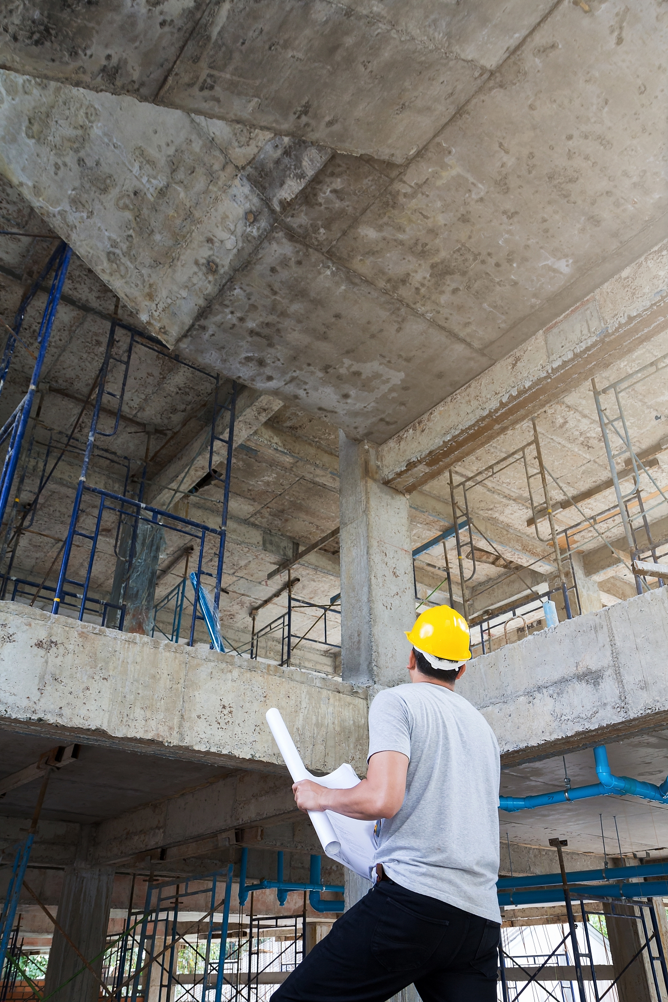 engineer with blueprint in building construction site
