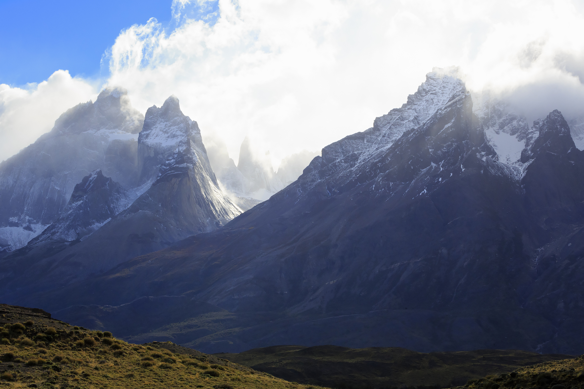 dramatic weather blows across the peaks of los cuernos.