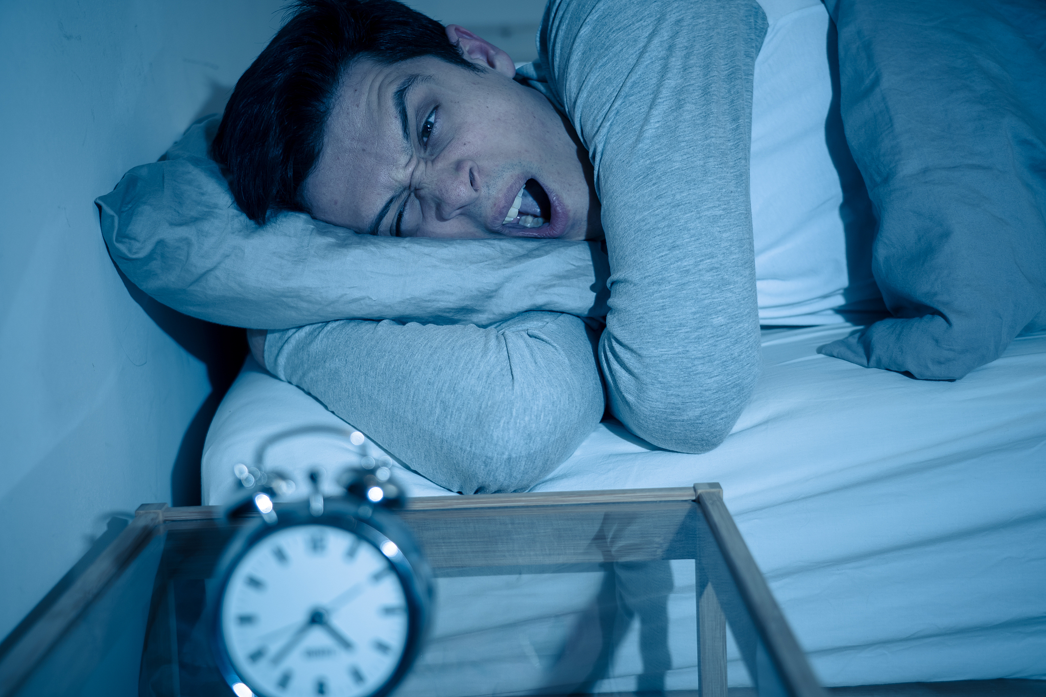 sleepless and desperate young man awake at night not able to sle