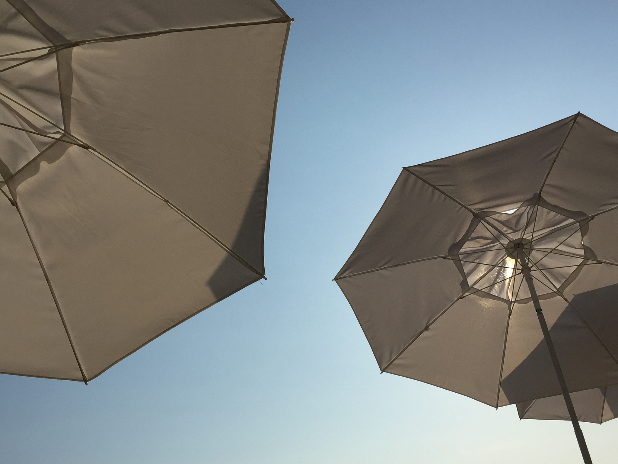white parasols, blue sky