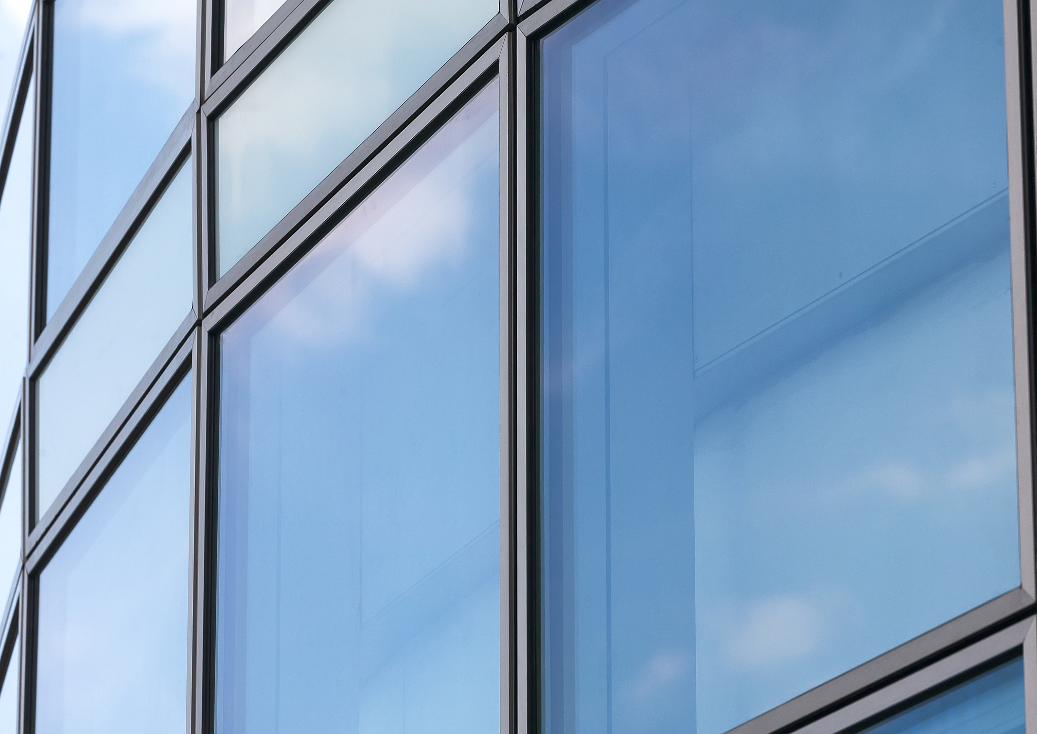 business abstract - modern office building covered with glass.