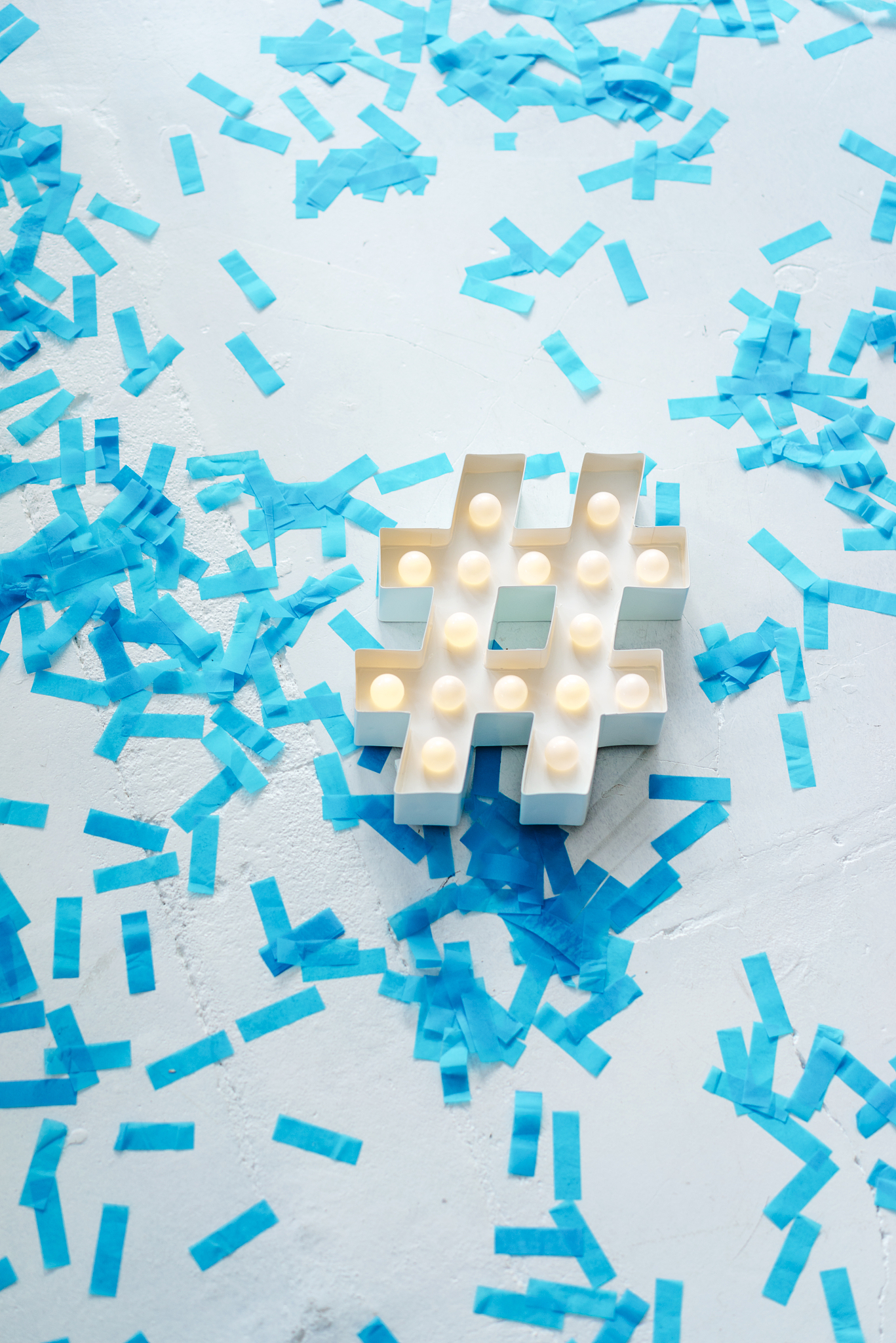 illuminated hashtag sign surrounded by confetti