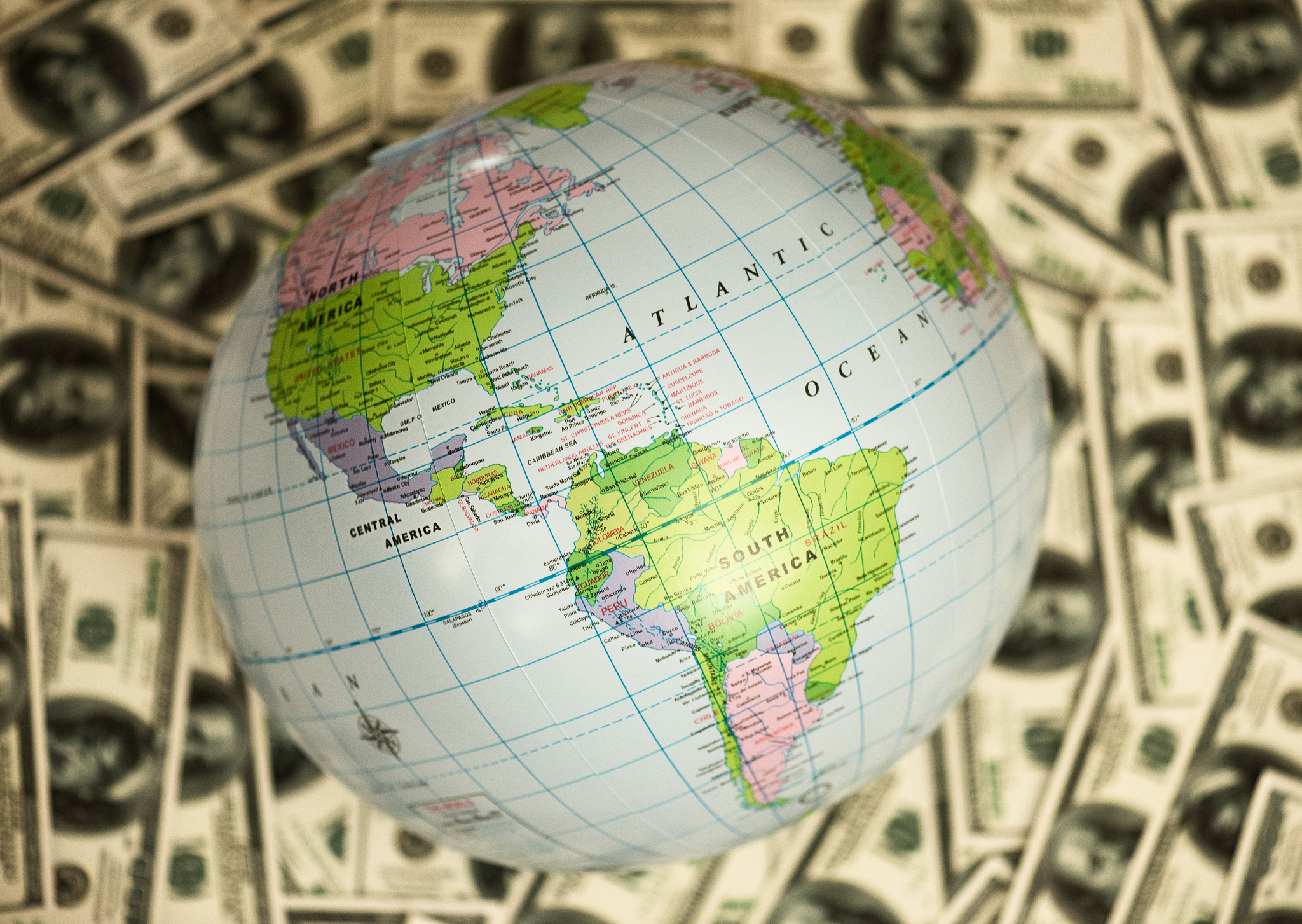 globe lying on the background full of money