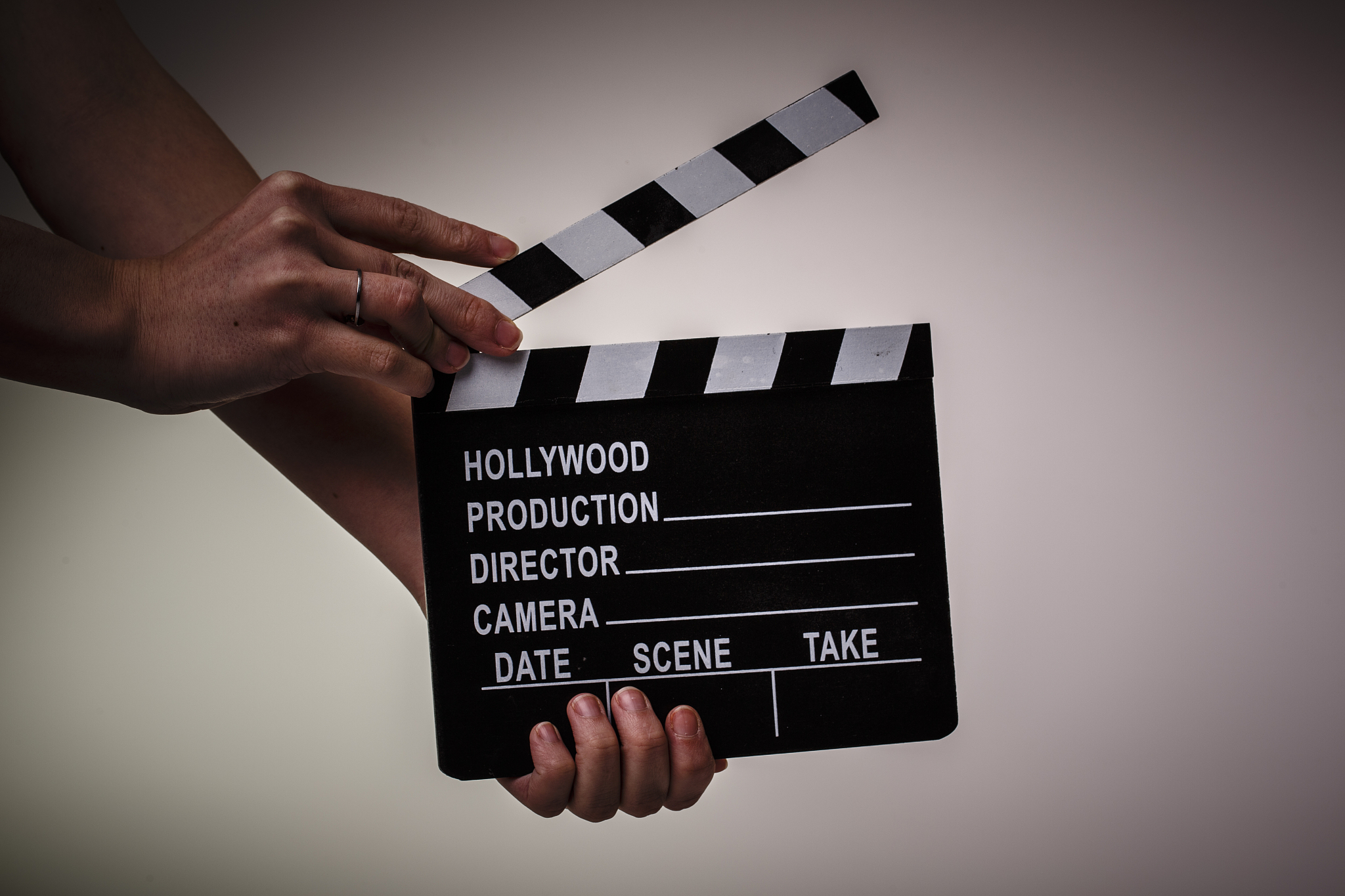 movie flapper in womans hands on white background