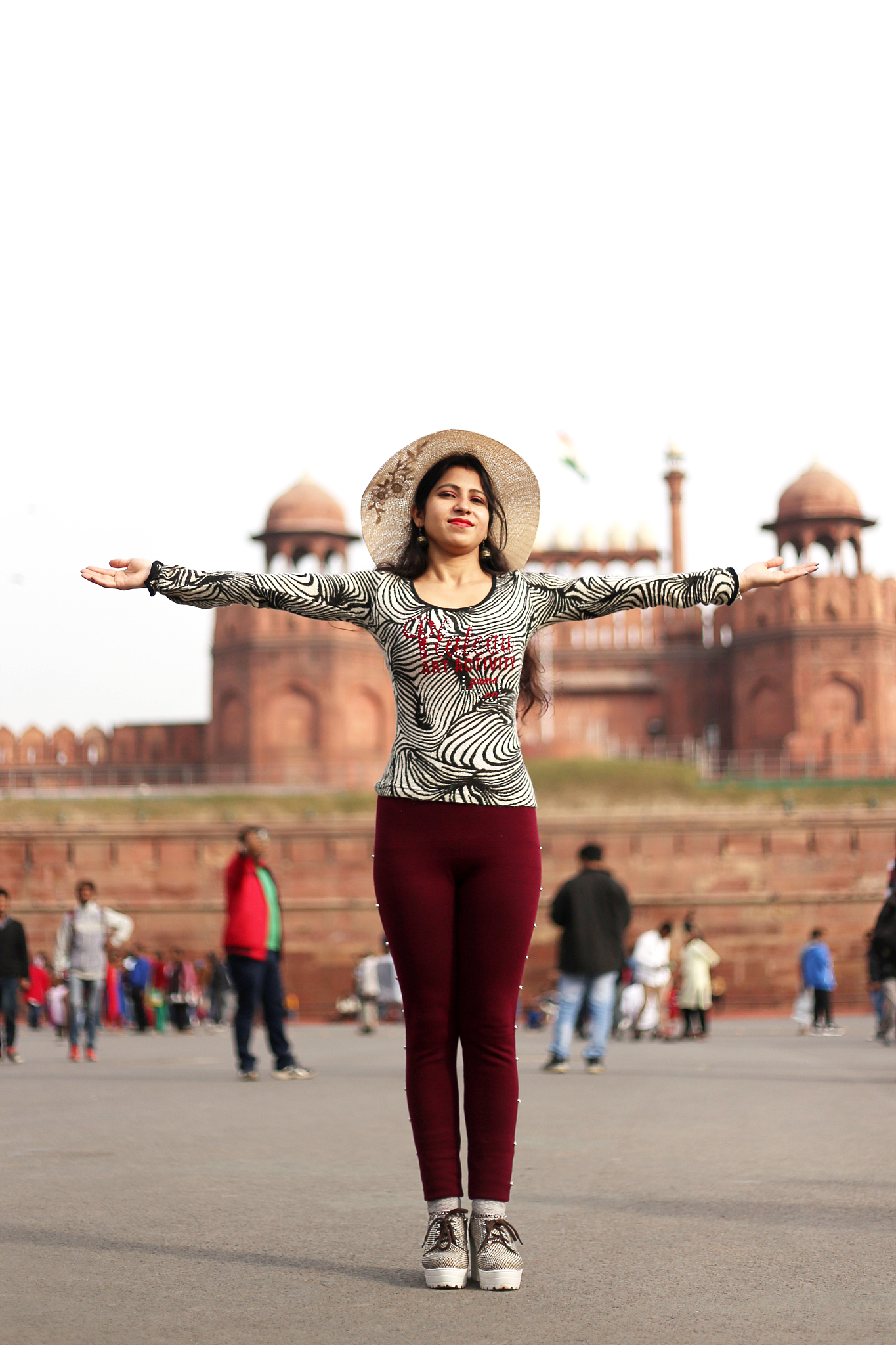 girl standing in front of red fort, delhi